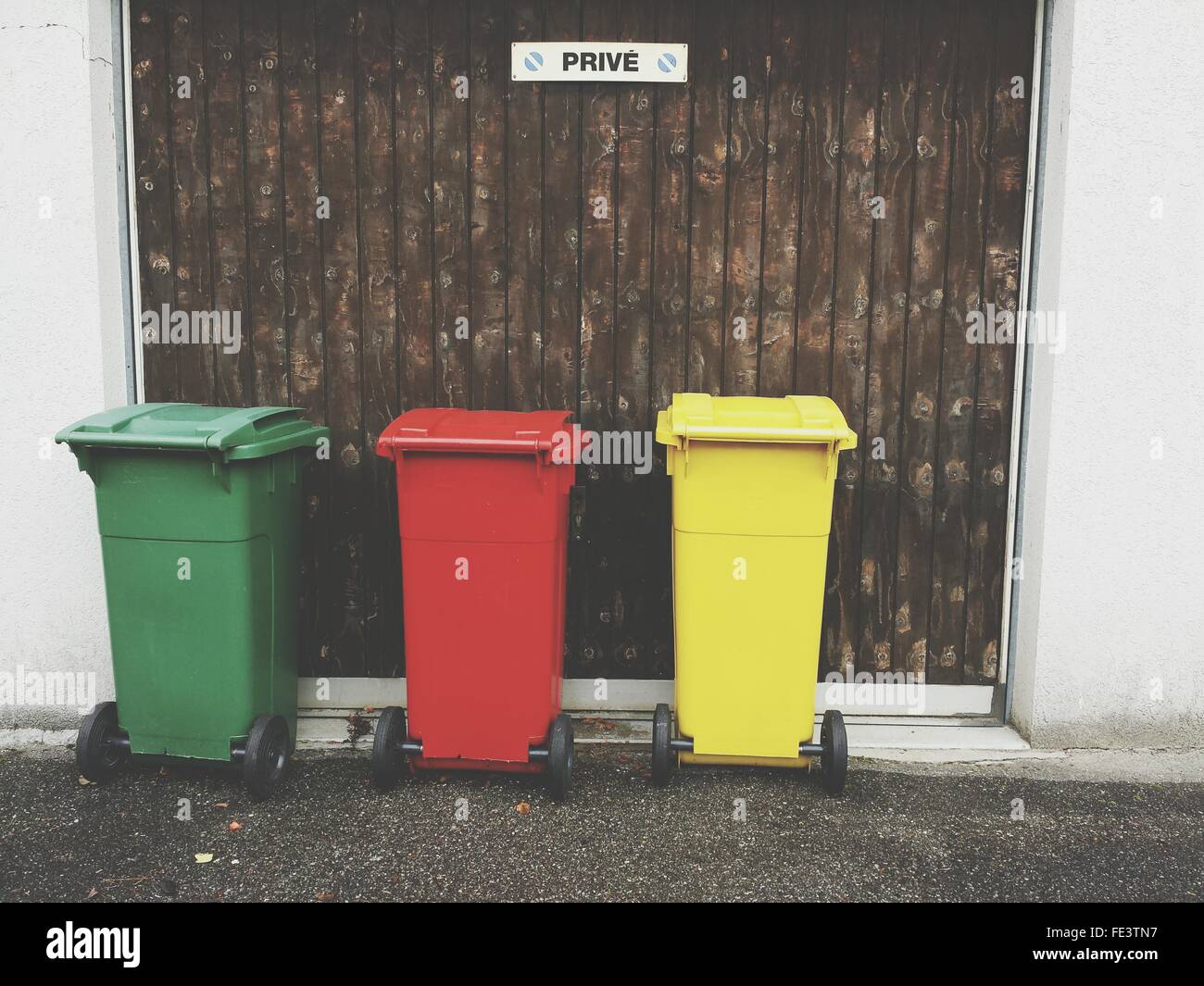 Multi Colored Garbage Bins Outside House Stock Photo Alamy