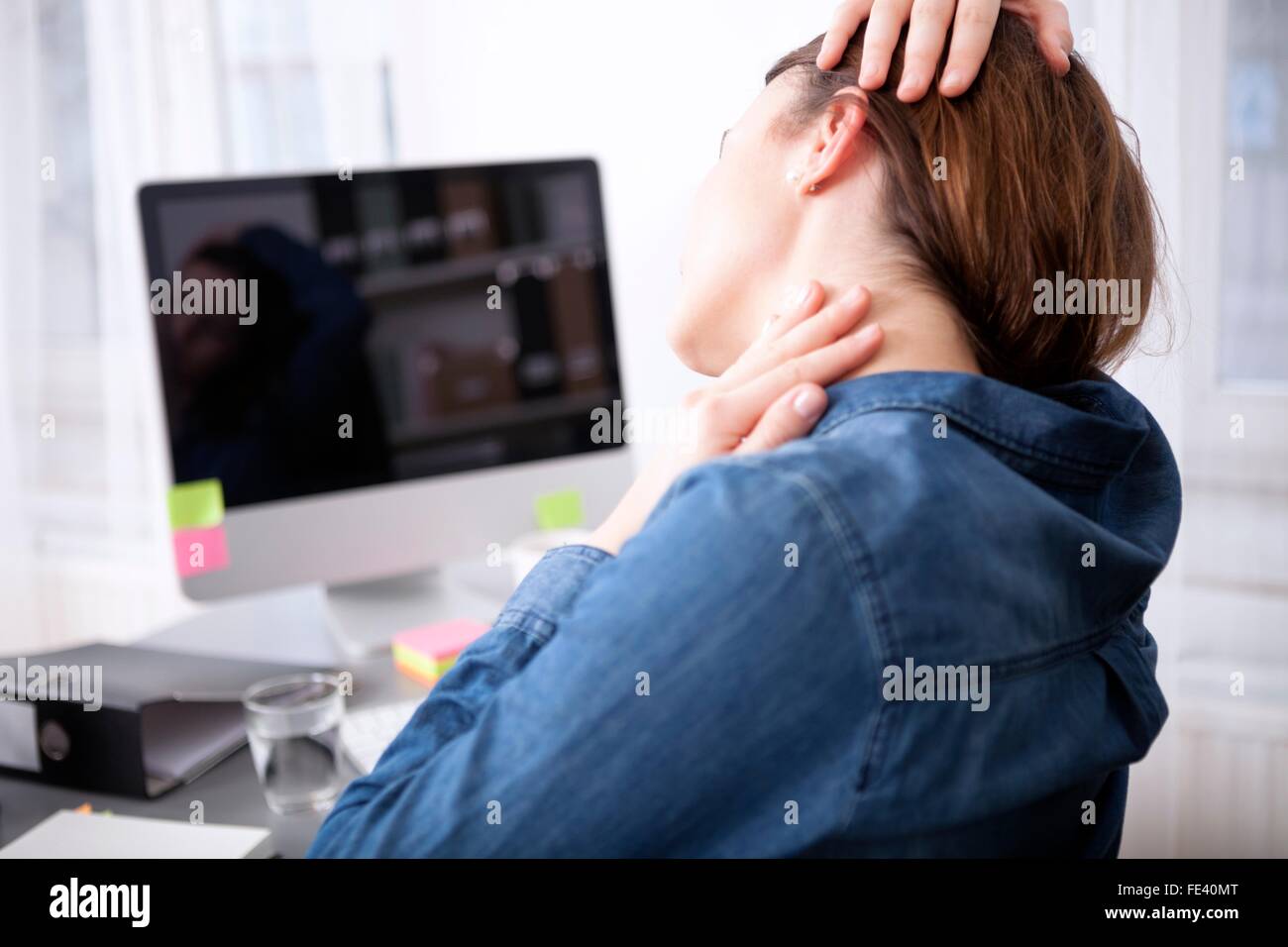 Close up rear View Tired Office Woman Sitting at her Desk Massaging her ...