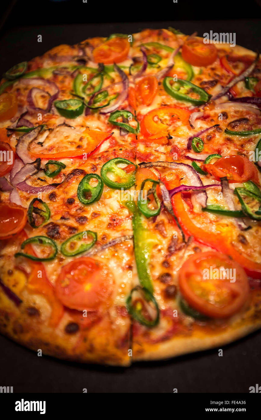 a thin crispy pizza in a Pizza Hut restaurant Stock Photo