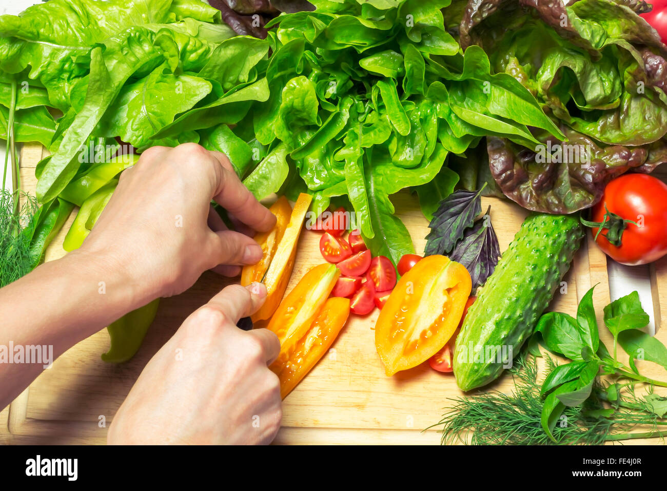 Fresh vegetables tasty cooking . In the presence of human hands . chopped tomatoes Stock Photo