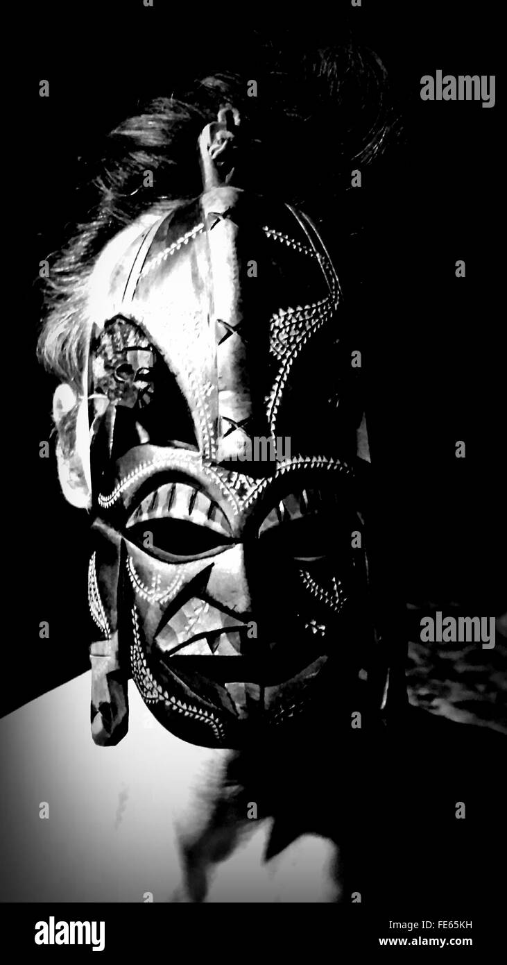 Man wearing traditional african mask stock image