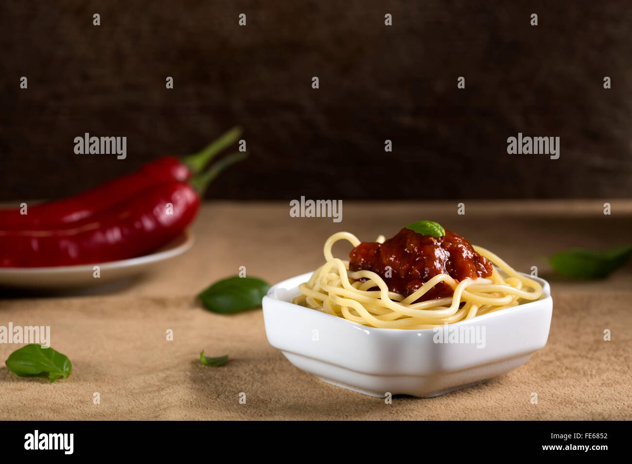Pasta with tomato sauce and basil on white bowl Stock Photo