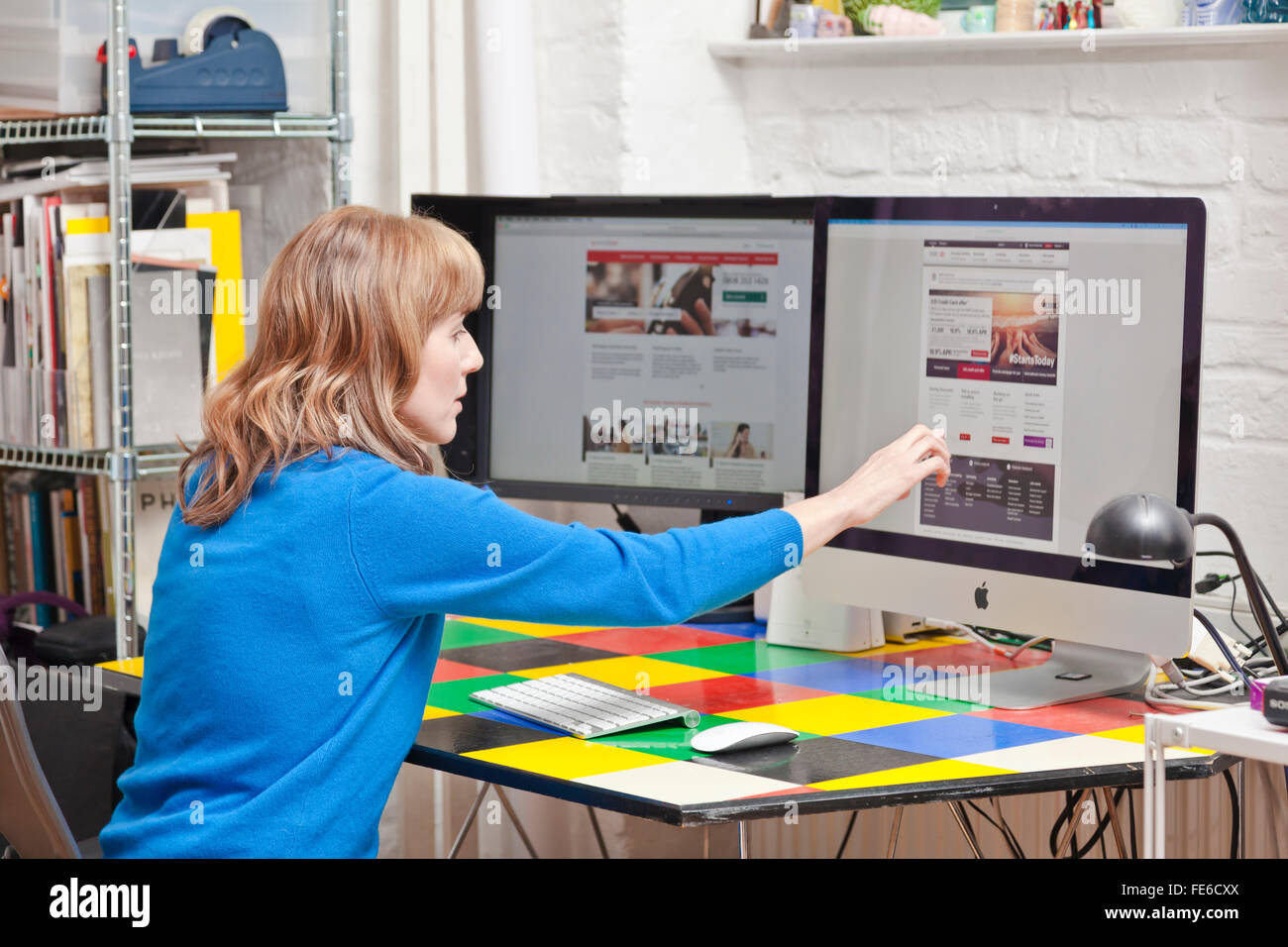 Woman checks her Internet bank account on a computer. Stock Photo