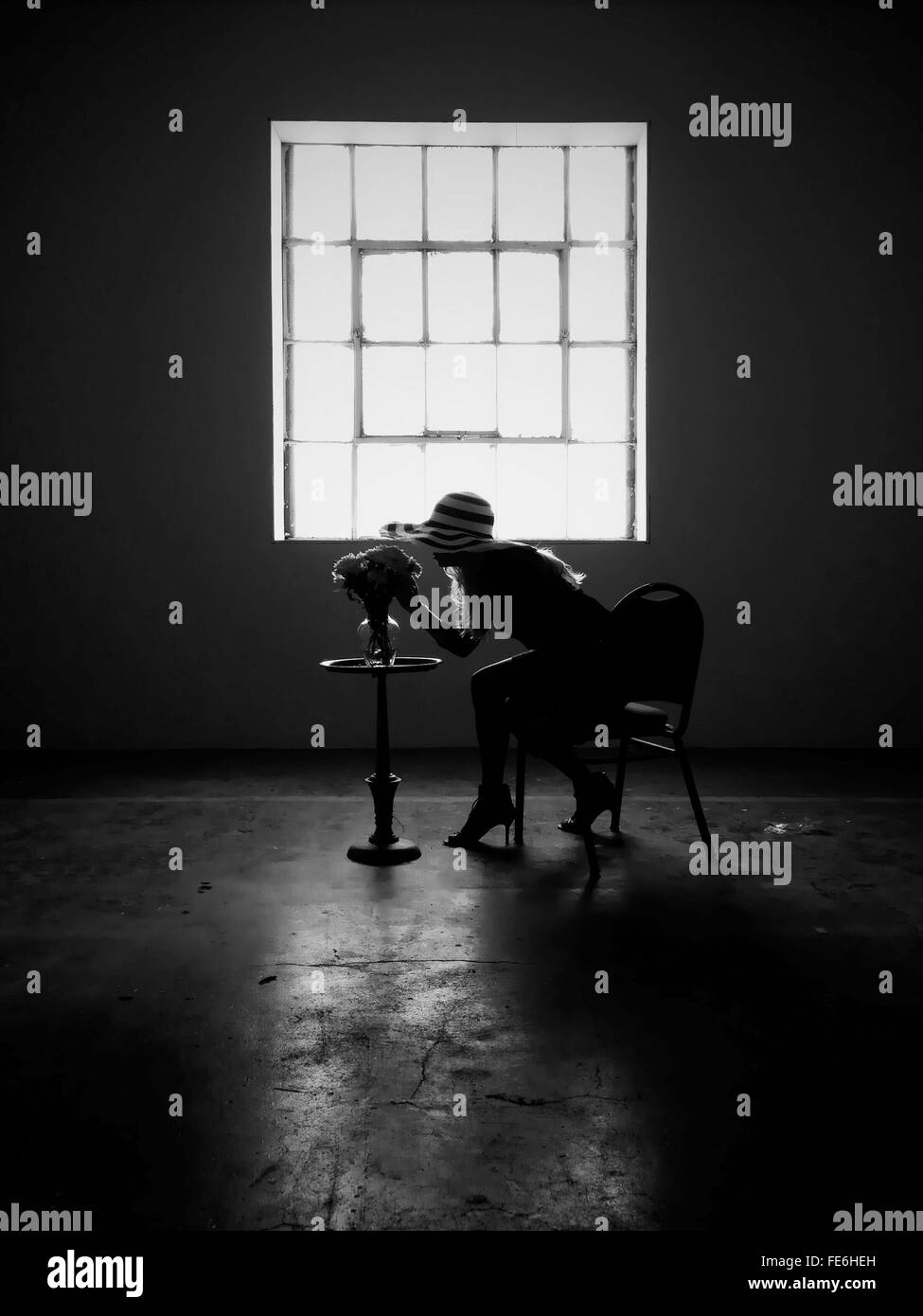Full Length Side View Of Woman Smelling Flowers In Vase Stock Photo Alamy