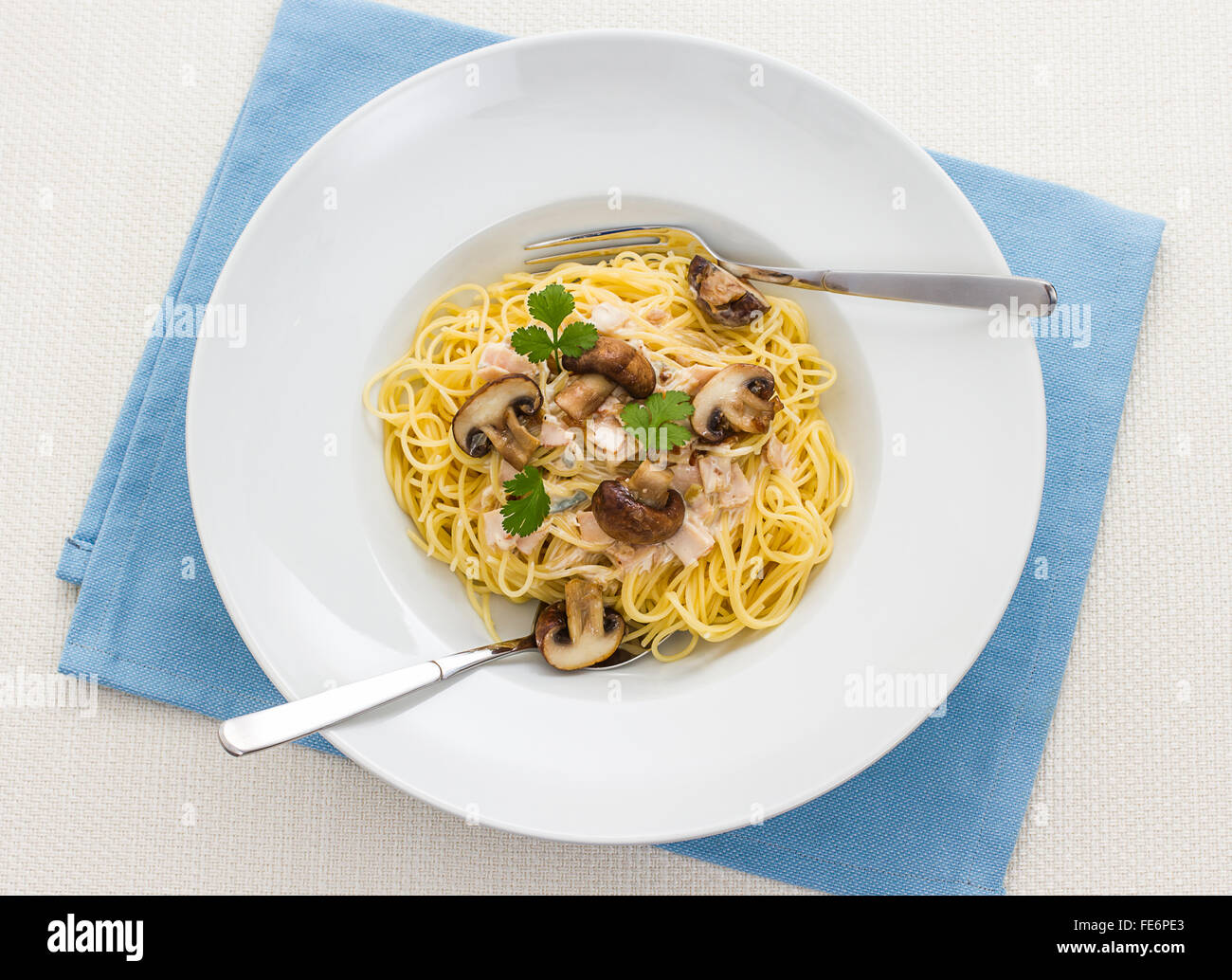 Spaghetti carbonara with brown mushroom in original pasta bowl Stock