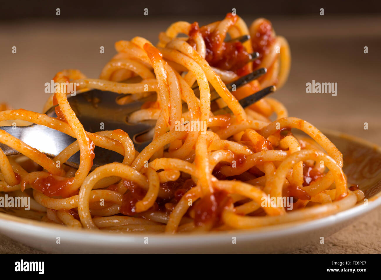 Spaghetti with tomato sauce and fork close up Stock Photo