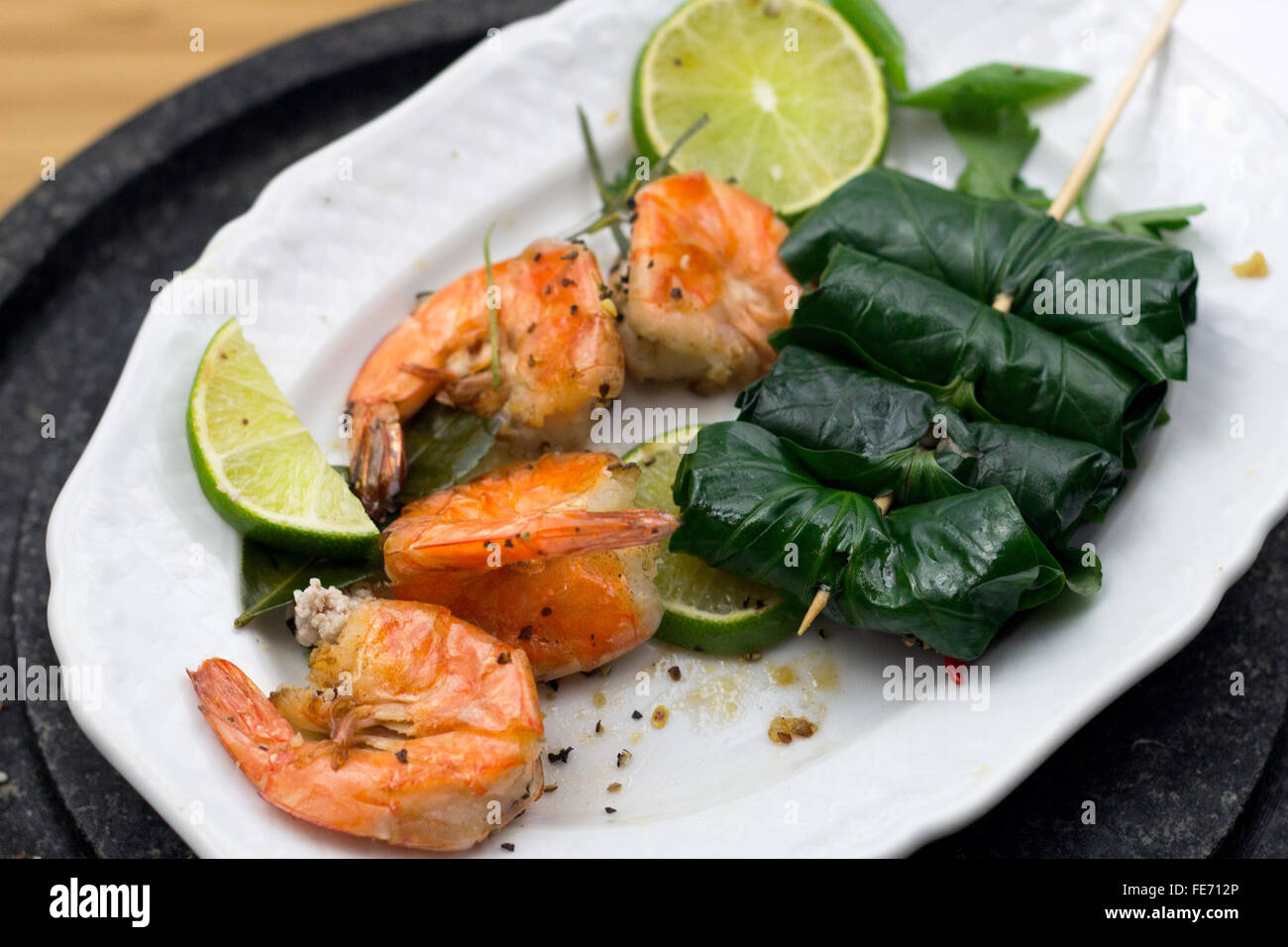 Thit Bo Nuong La Lot filled Wine leaf , Vietnamese Traditional Dish Food, Starter, Appetizer served with Limes Stock Photo
