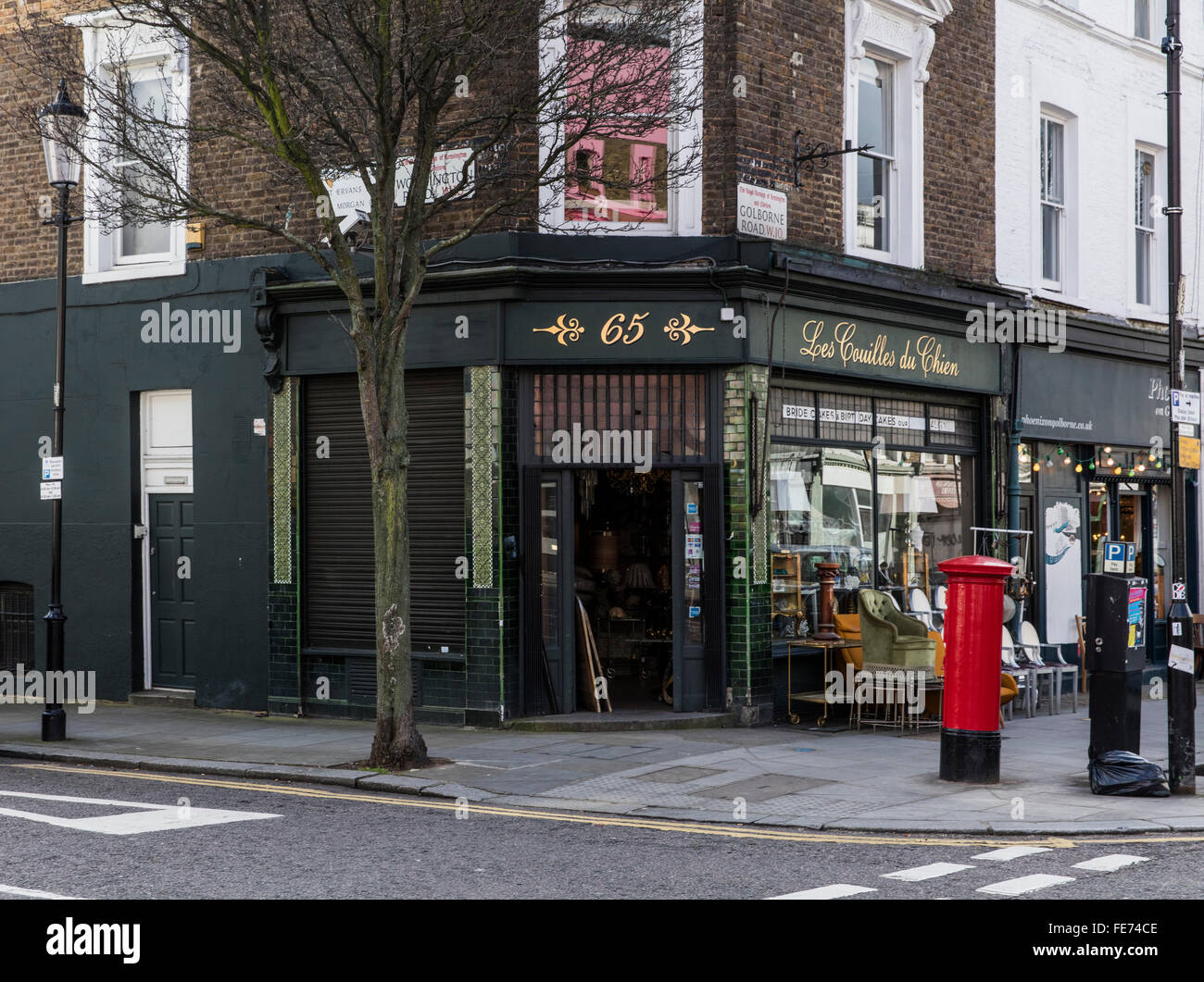 Great antique shop in London's Portobello Road W10 selling junk and antiques with a great name in quite rude French. Stock Photo