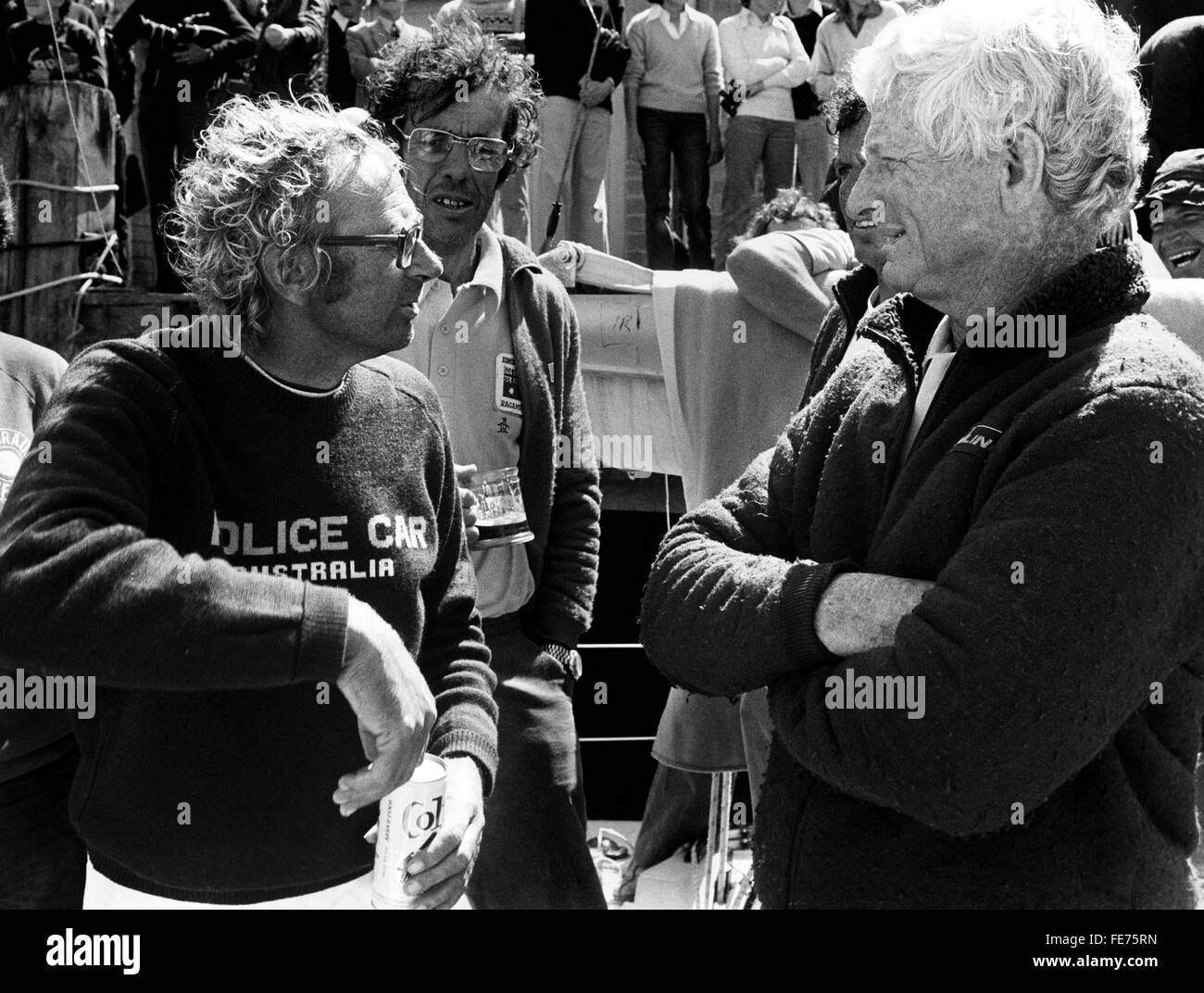 AJAXNETPHOTO - 15th August, 1979. PLYMOUTH, ENGLAND - FASTNET RACE - (r-l) SYD FISCHER (AUS) SKIPPER OF THE YACHT RAGAMUFFIN AND PETER CANTWELL (AUS), SKIPPER OF POLICE CAR DISCUSS THEIR EXPERIENCES IN THE STORMY RACE. PHOTO:JONATHAN EASTLAND/AJAX REF: 79108 1 Stock Photo