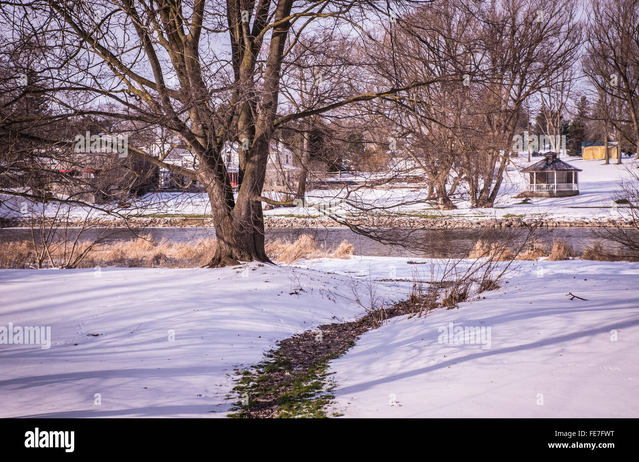 Path to the River  -  Winter country landscape with a walking path to a slow-flowing river Stock Photo