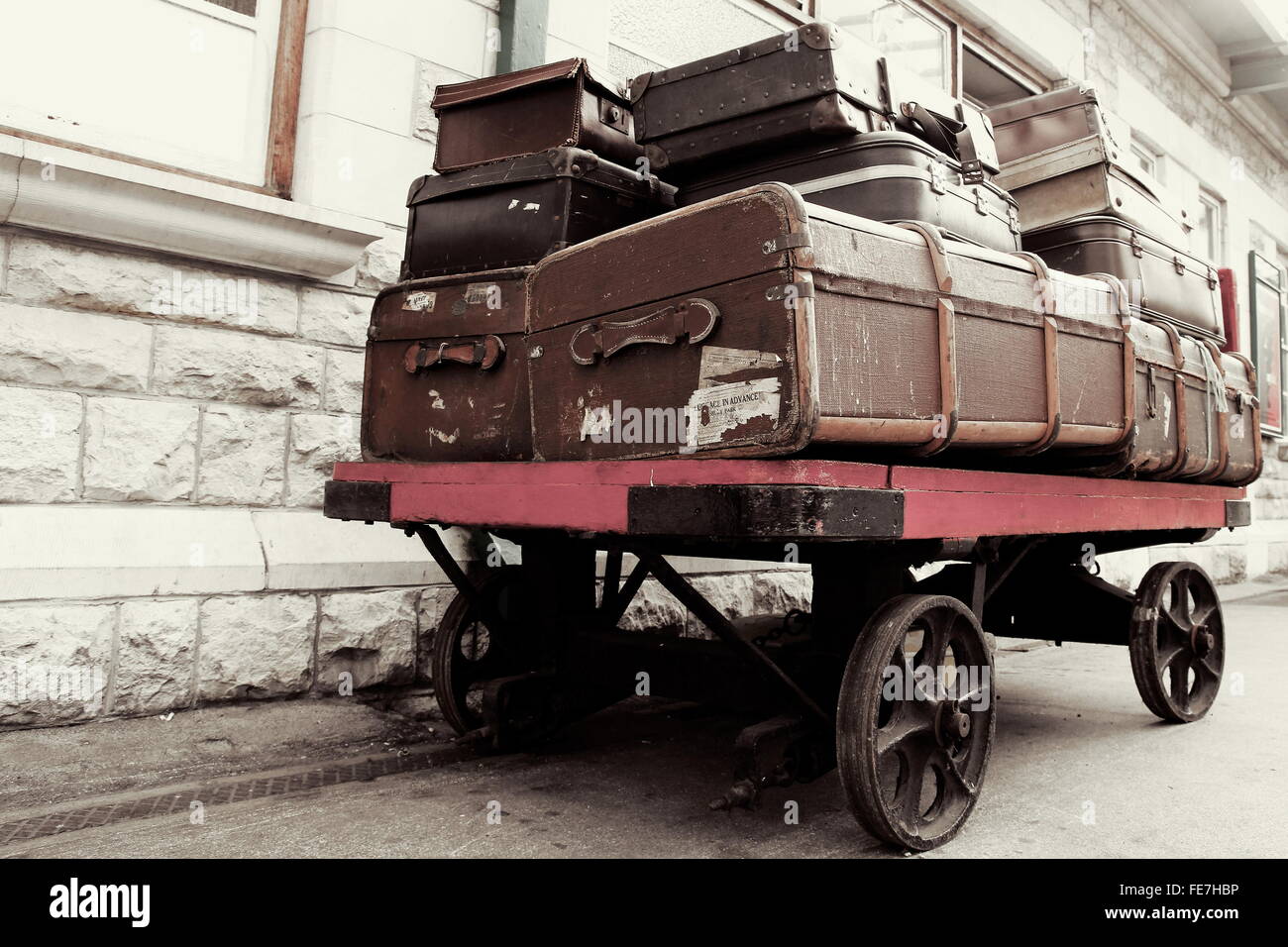 Vintage retro luggage on an antique railway station trolley, waiting
