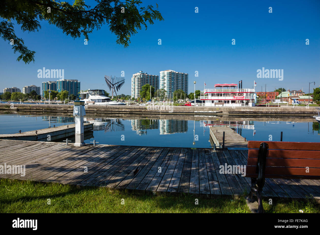 Marina docks in Barrie Ontario with tour boat and apartment buildings in the background. Stock Photo