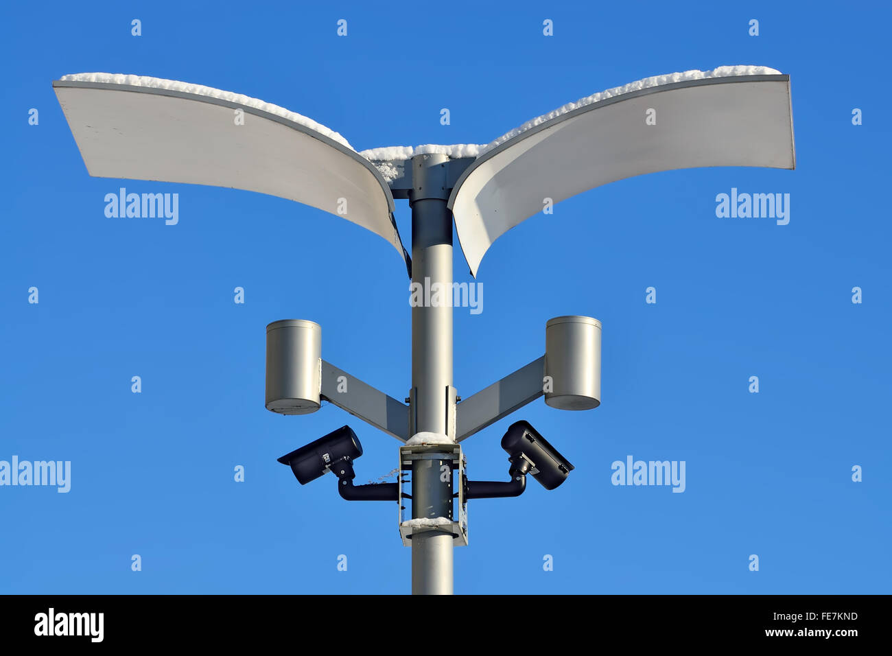 Surveillance cameras and modern lighting fixtures on the lamppost Stock