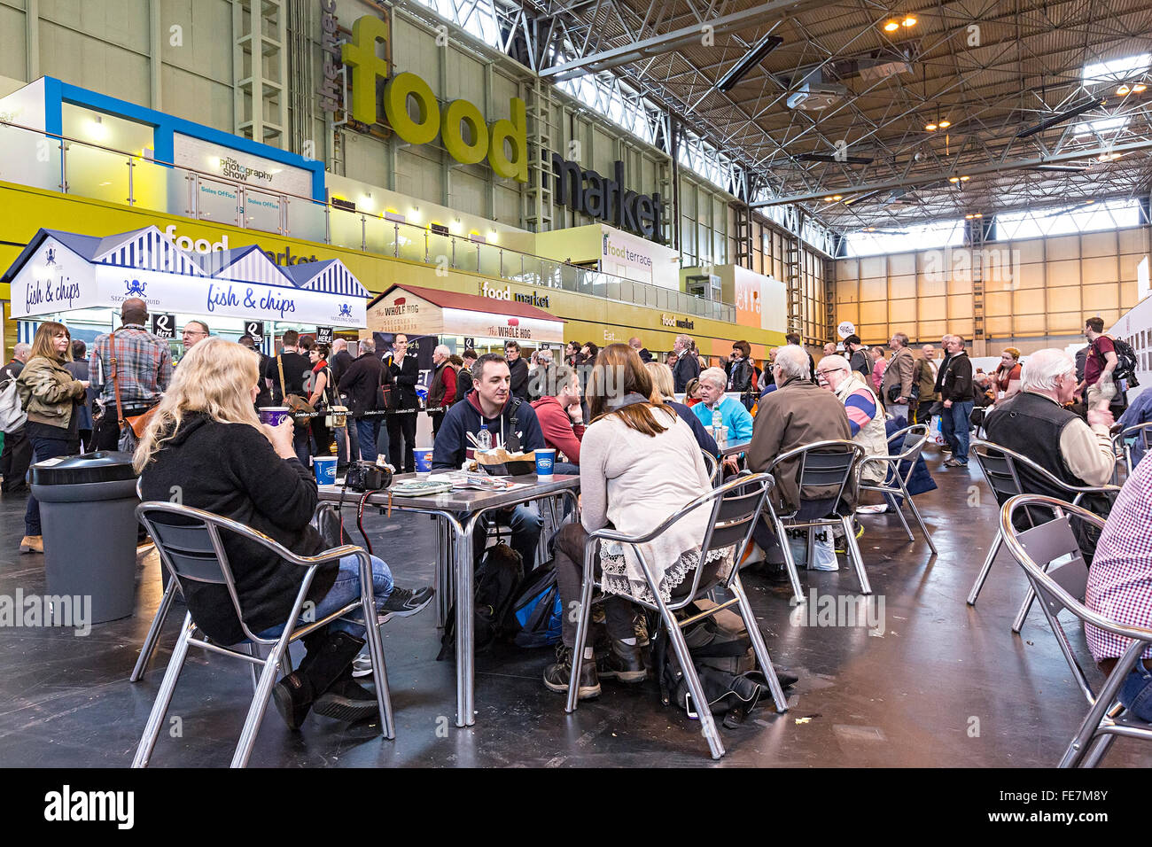People eating in the food market area of the NEC, National Exhibition