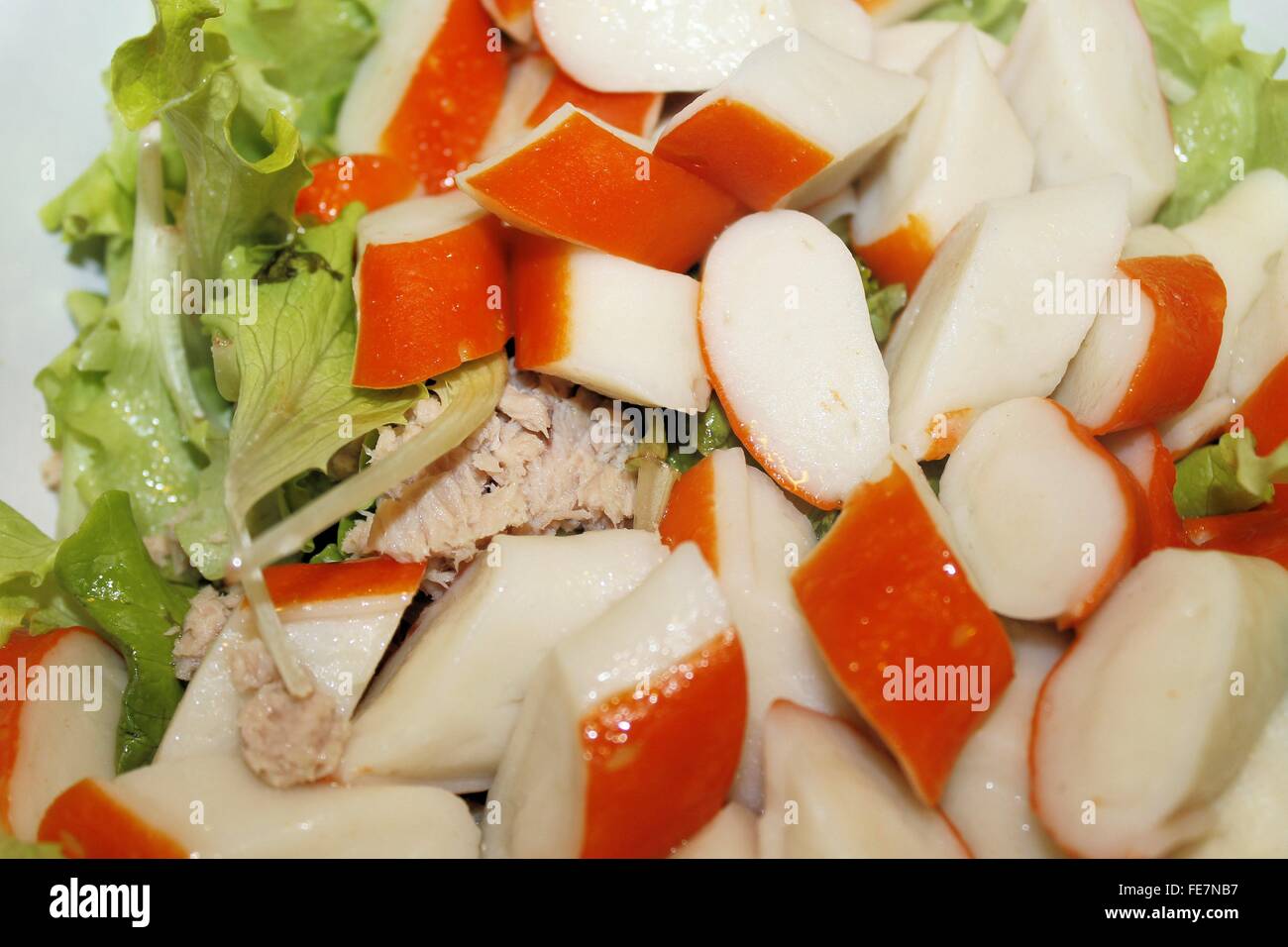 Salad with pieces of red crab stick and fresh lettuce Stock Photo