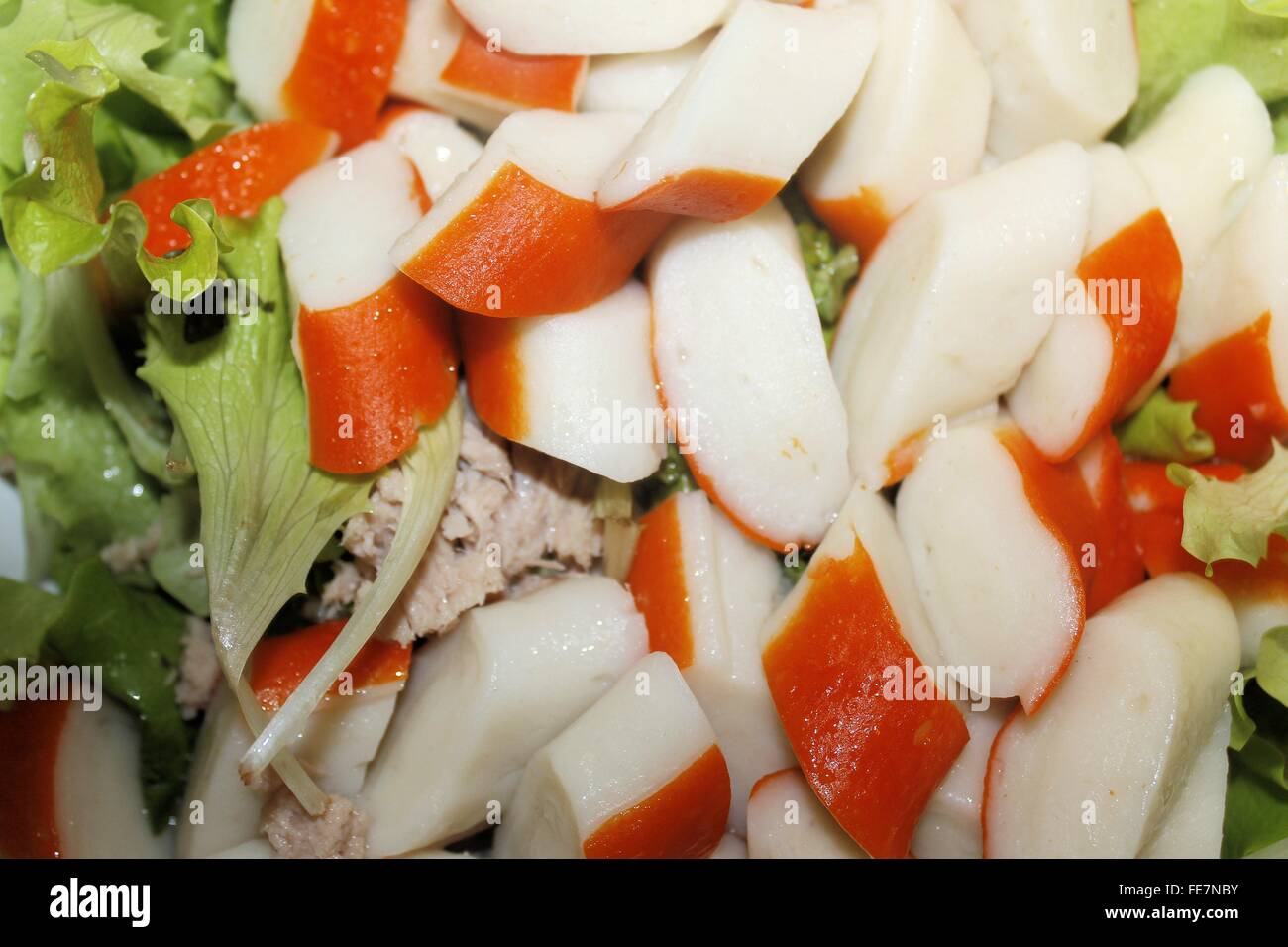 Salad with pieces of red crab stick and fresh lettuce Stock Photo