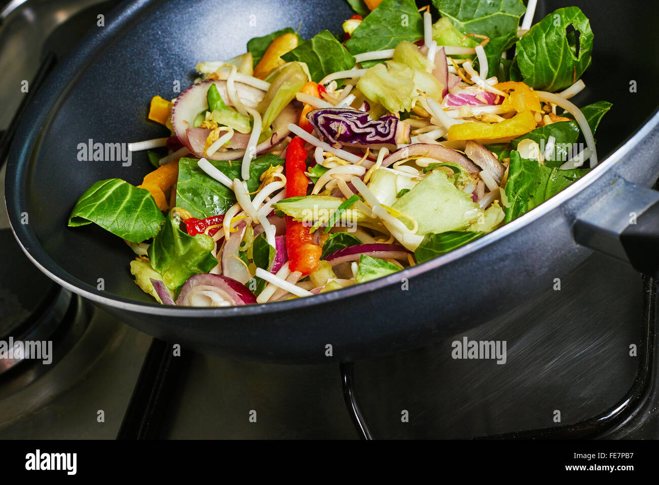 Cooking stir fry vegetables on a stove Stock Photo Alamy
