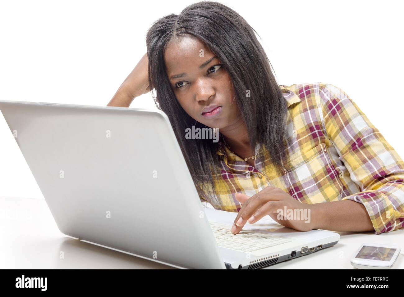 a young African american working on laptop on the white background ...