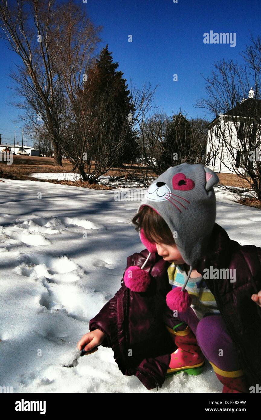 Little Girl Playing With The Snow Stock Photo