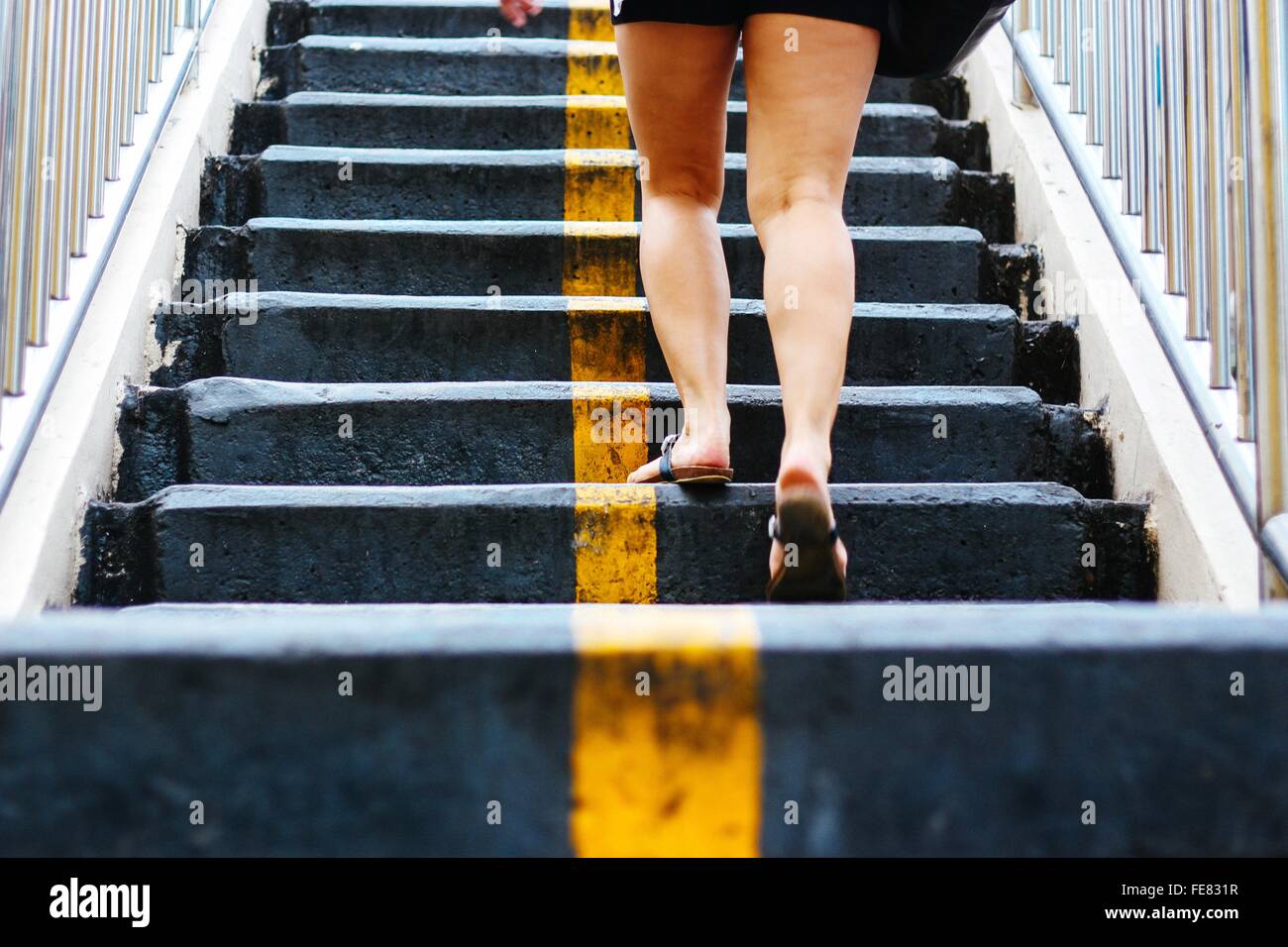 Person walking up stairs hi-res stock photography and images - Alamy