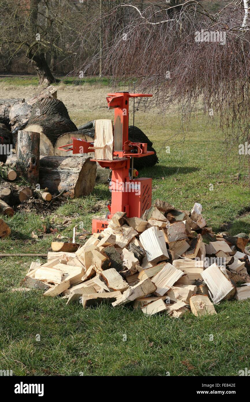 Stack Of Wood Cubes And Cutting Implement On Grassland Stock Photo
