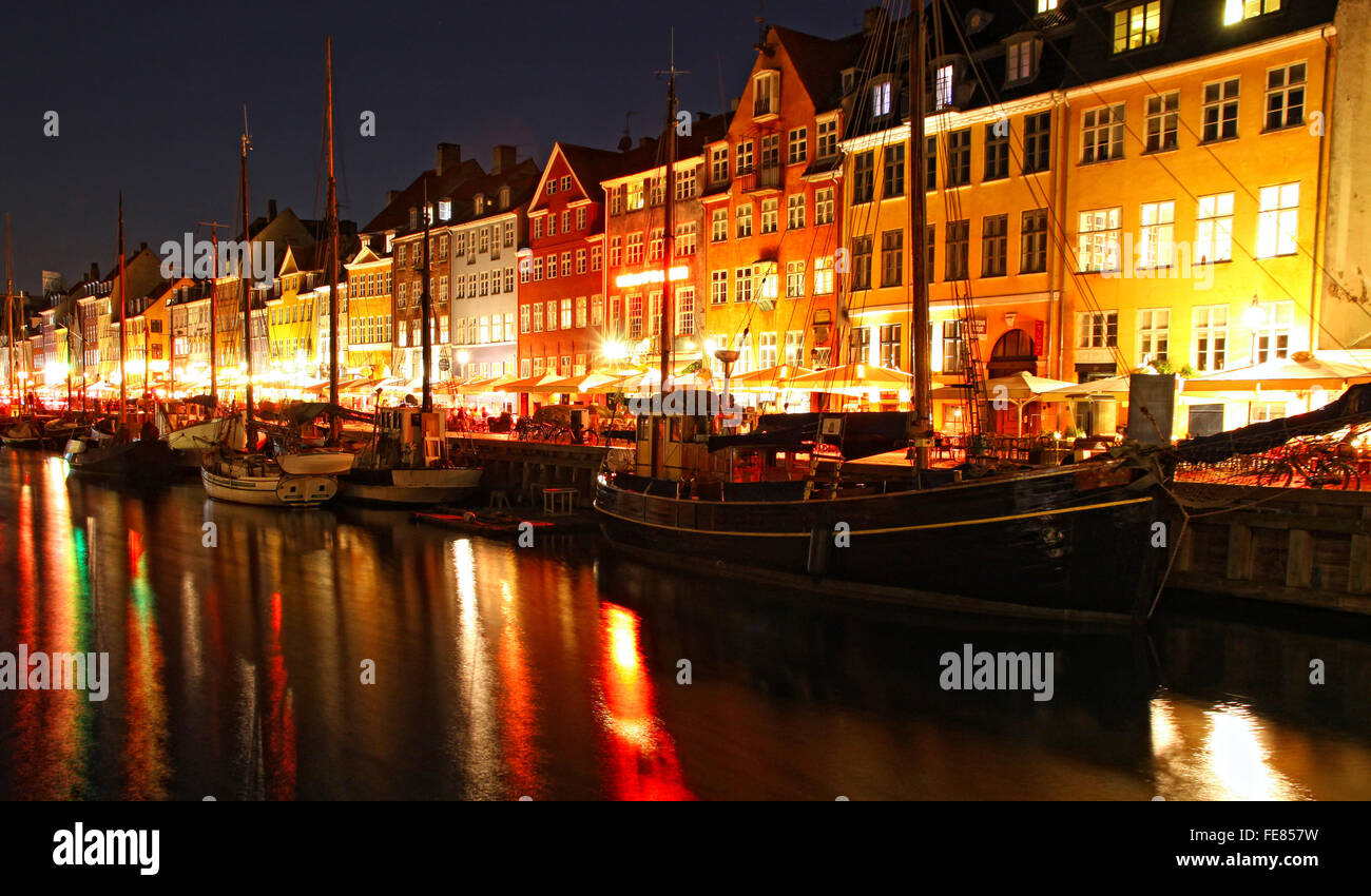 Boats at the Nyhavn harbor in night, Copenhagen, Denmark. Nyhavn is a famous 17th century embankment, canal and entertainment ar Stock Photo