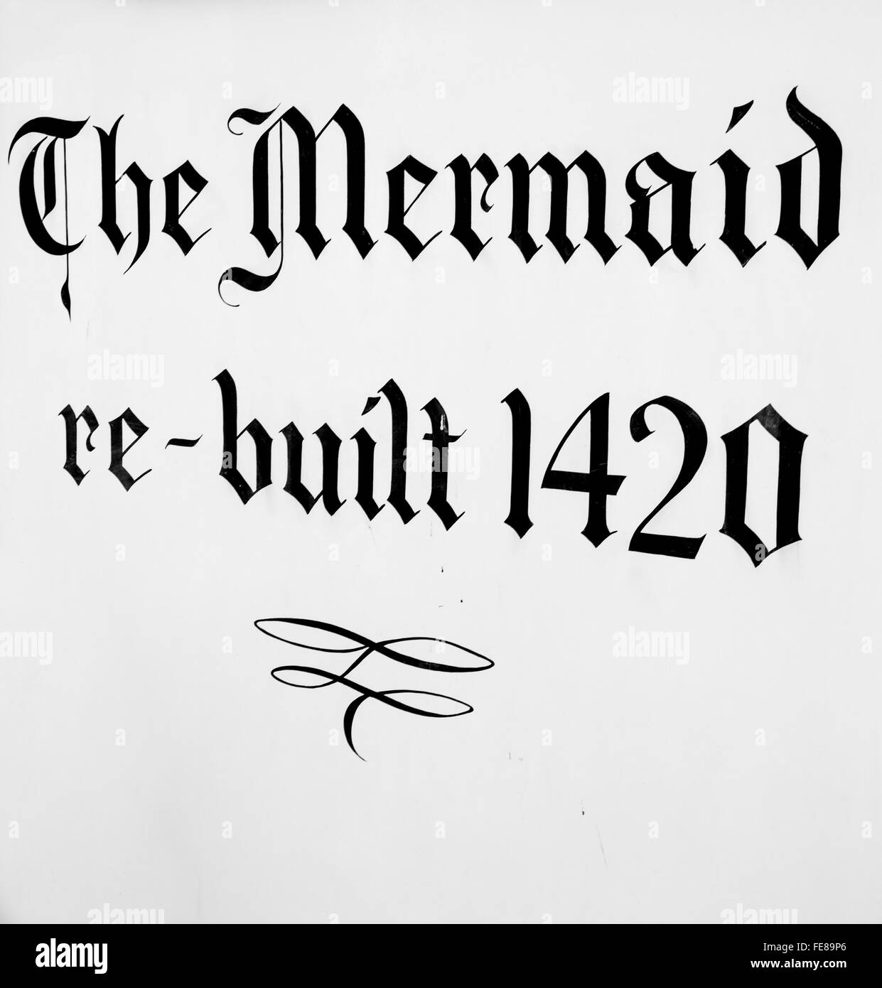 Sign painted on the building of The Mermaid Inn in Rye, East Sussex, UK. Rebuilt in 1420, now a popular inn and hotel. Stock Photo