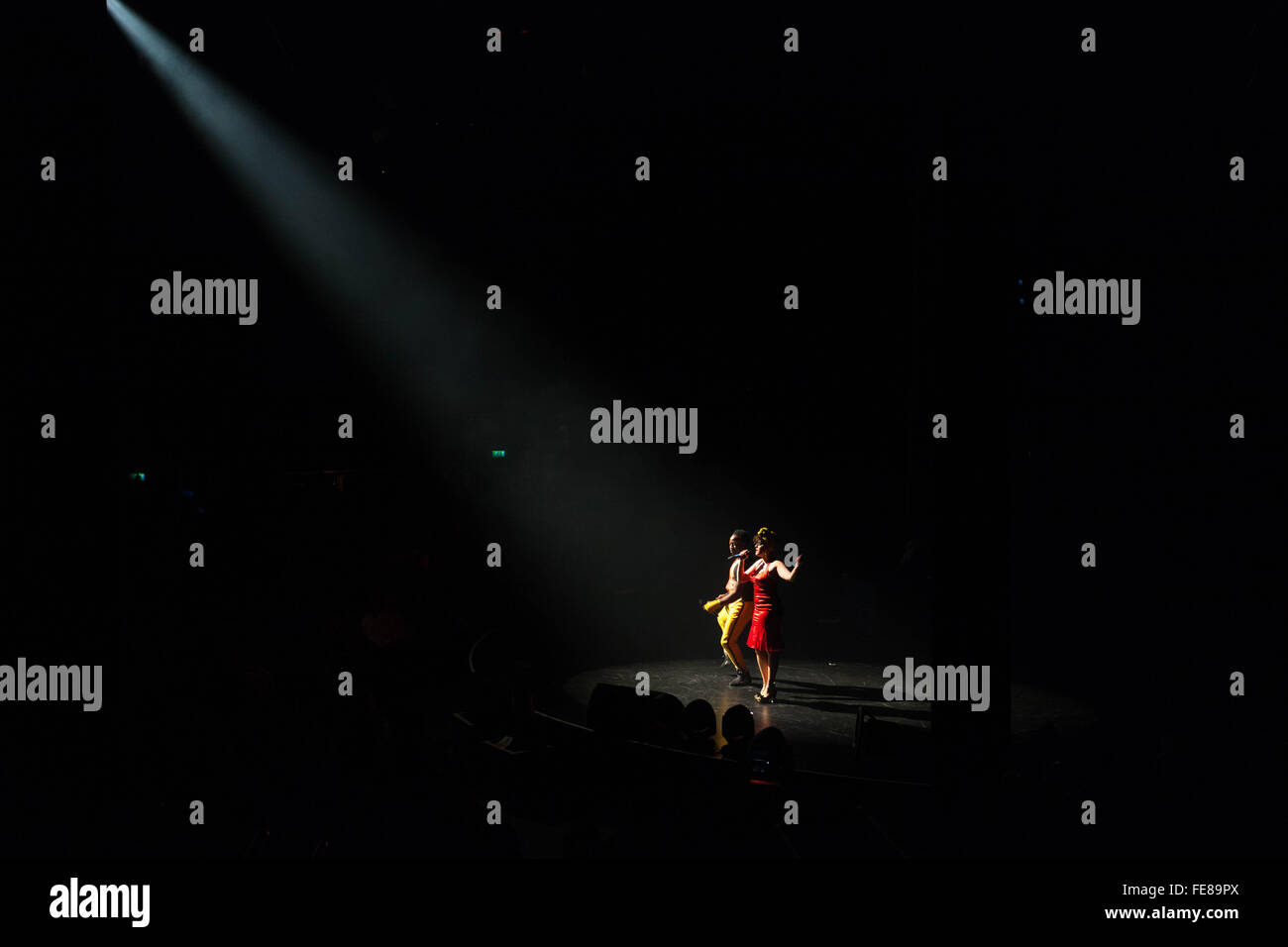 A duo of female performers singing on stage, under the spotlight, Circolombia Circus, Roundhouse, Camden, London, England, UK. Stock Photo