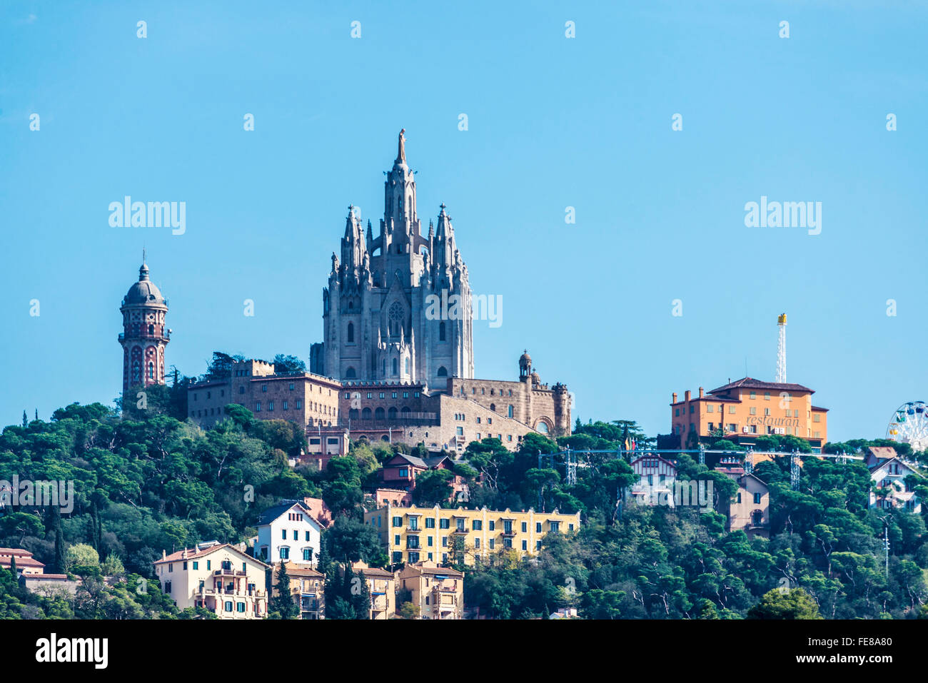 View of Tibidabo amusement park and of houses around them in Barcelona, Catalonia, Spain Stock Photo