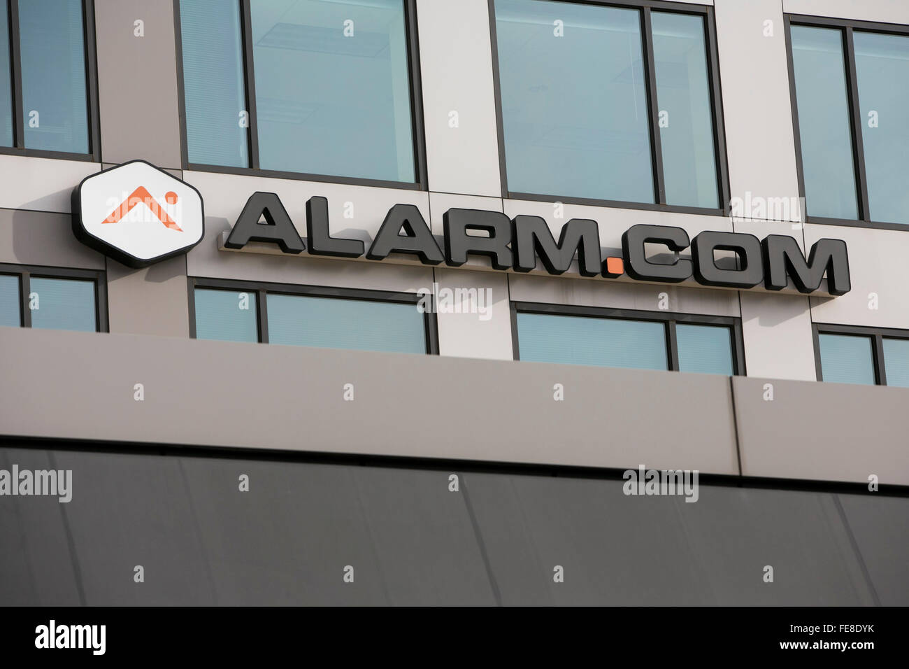 A logo sign outside of the headquarters of Alarm.com, Inc., in Tysons, Virginia on January 1, 2016. Stock Photo