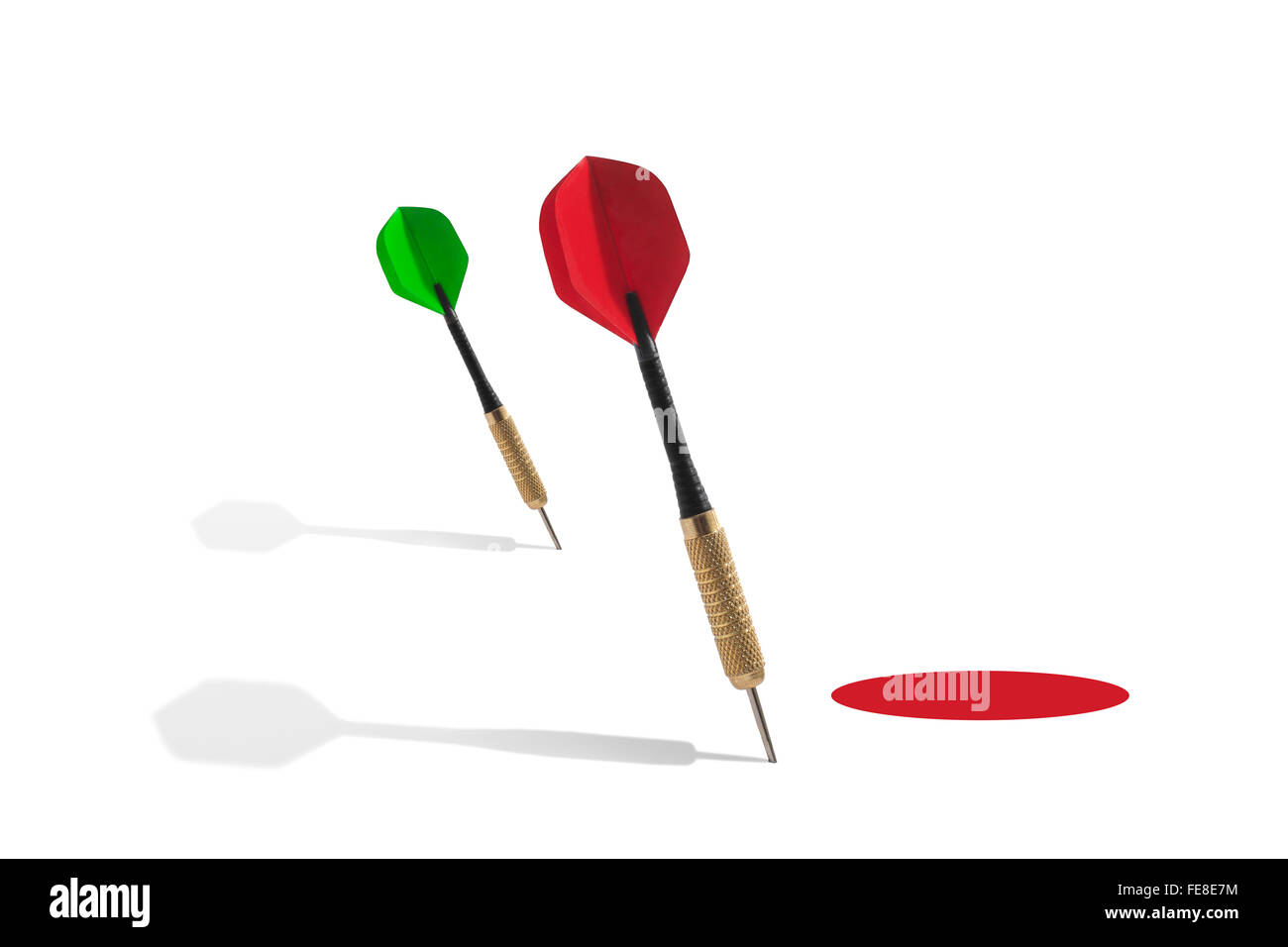 Darts Outside of a Red Target on a White Background Stock Photo