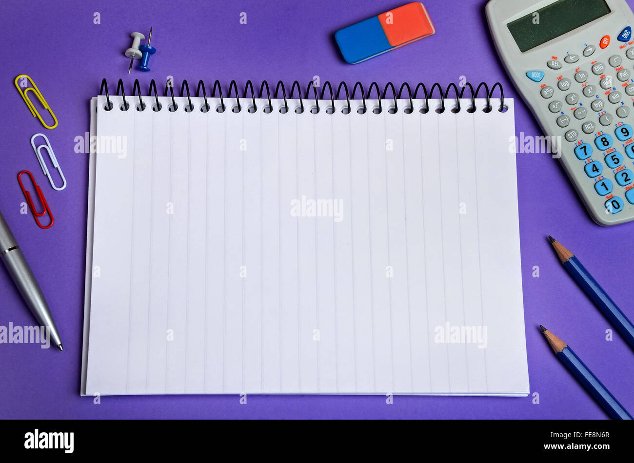 Assorted office supplies on purple background Stock Photo