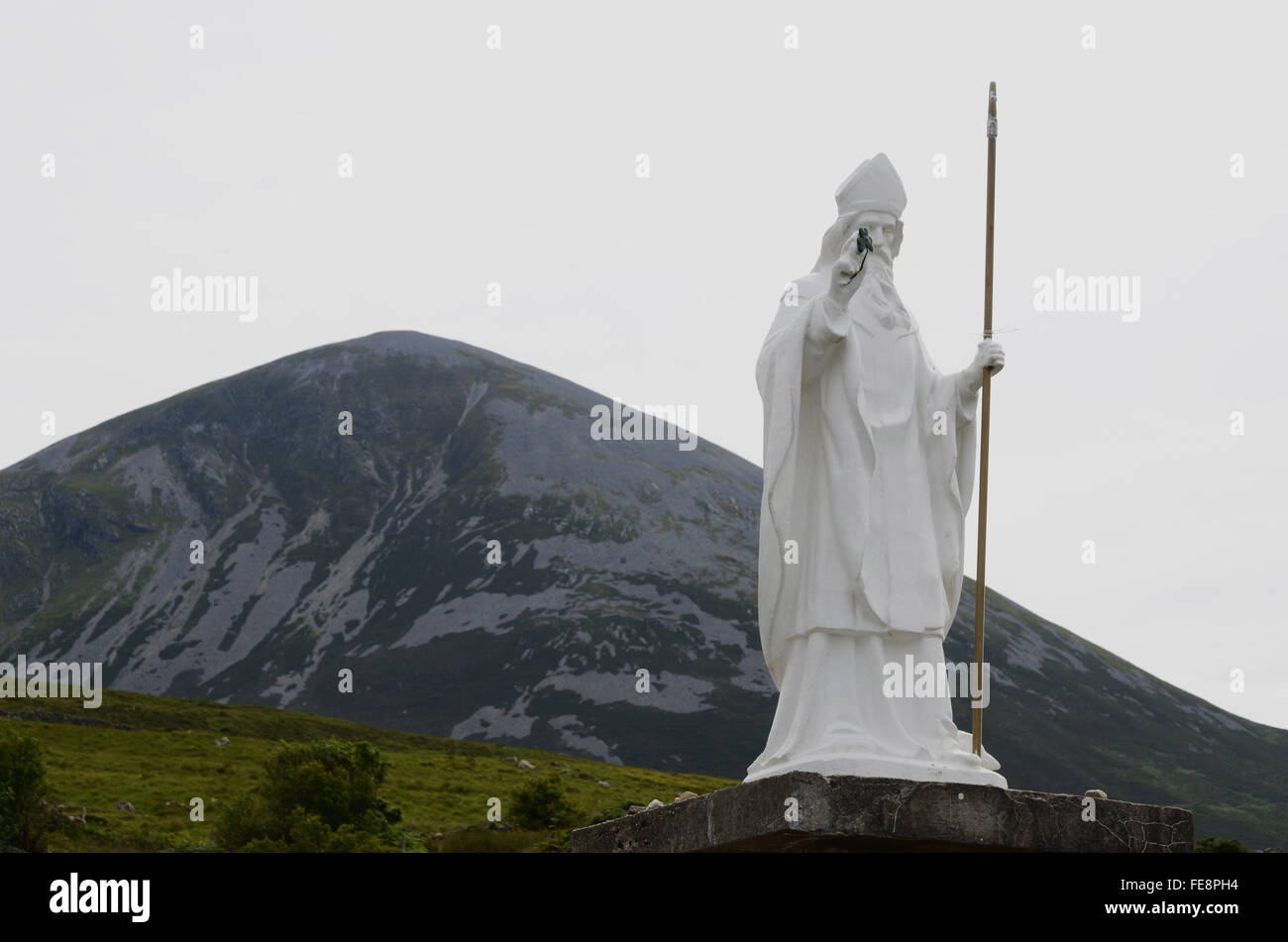 Statue In Front Of Barren Mountain Top Stock Photo Alamy