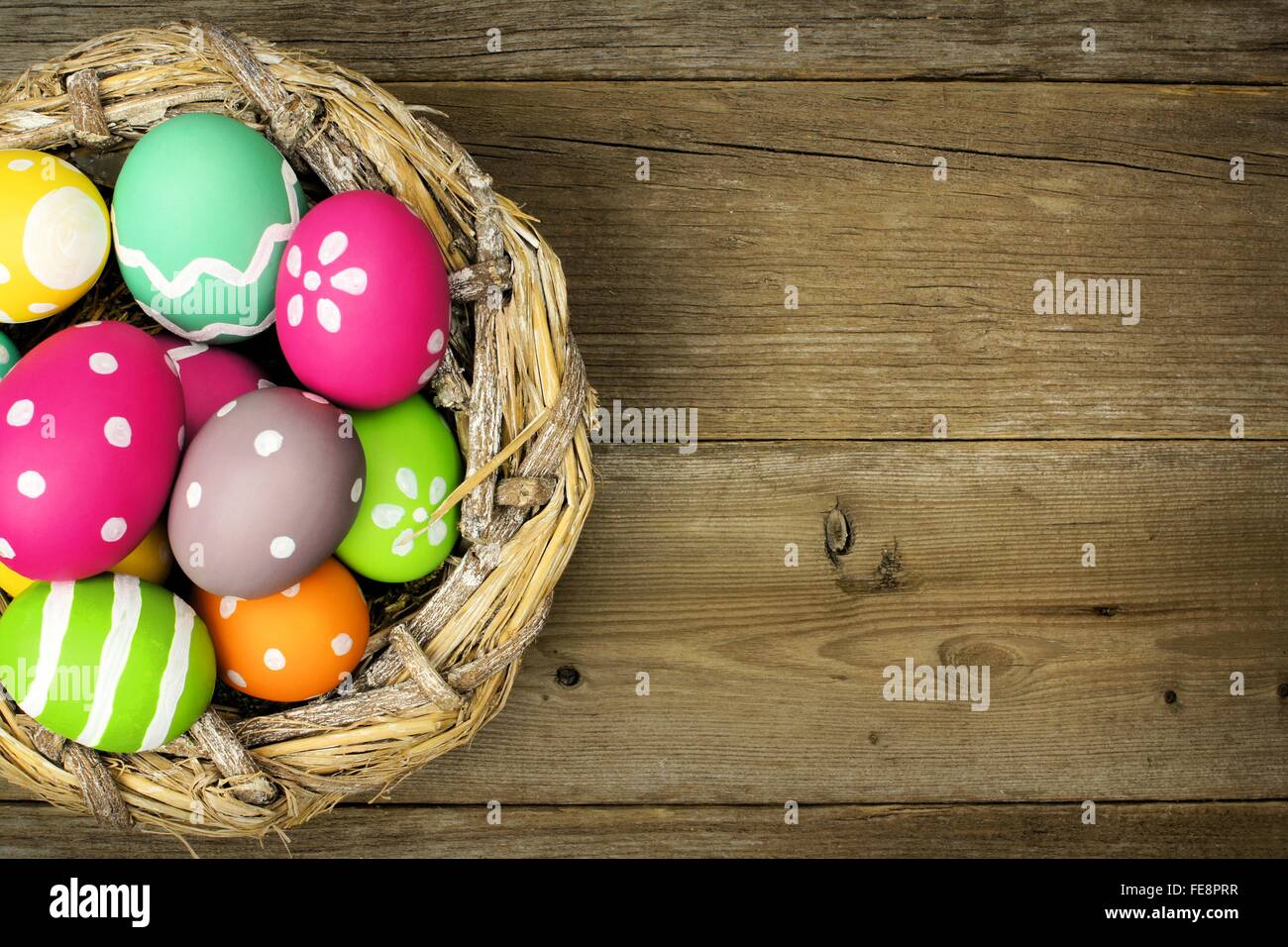Easter eggs in a nest over an old wood background Stock Photo - Alamy