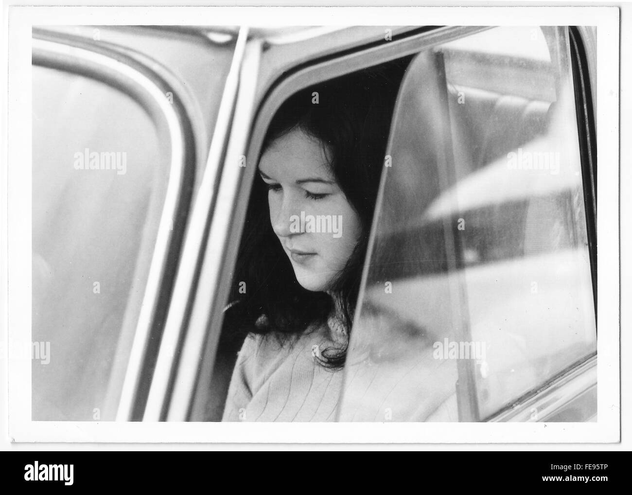 Young woman 1960s 1970s inside a vintage Fiat car. Black and white film Stock Photo