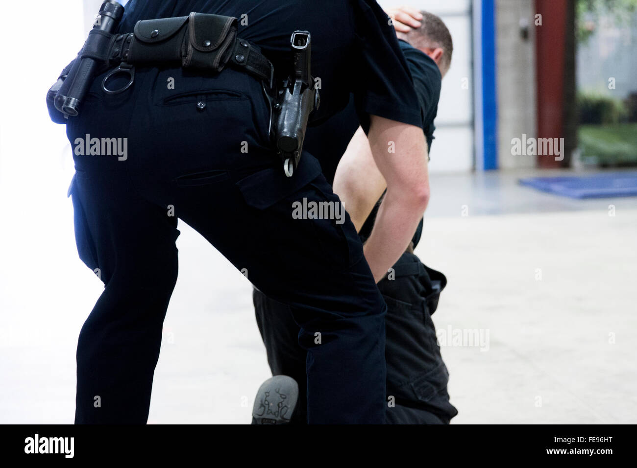 A police officer arresting a suspect. Stock Photo