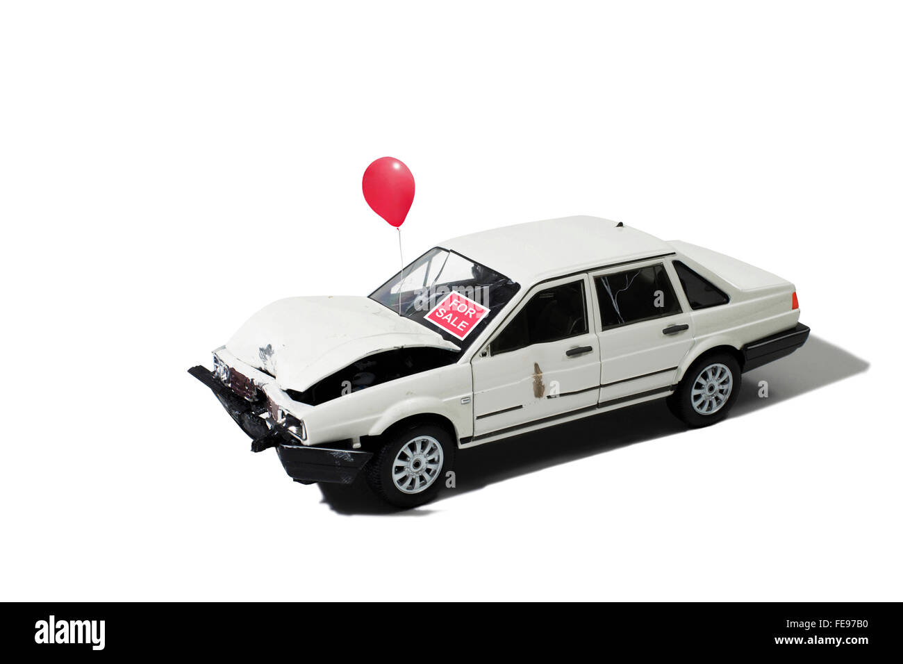 Wrecked Automobile for Sale with Balloon on a White Background Stock Photo