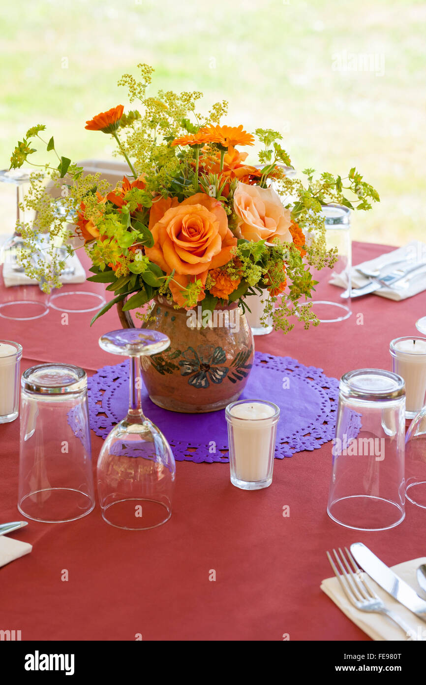 Casual table setting with glassware and bouquet of flowers at ... Casual table setting with glassware and bouquet of flowers at ...