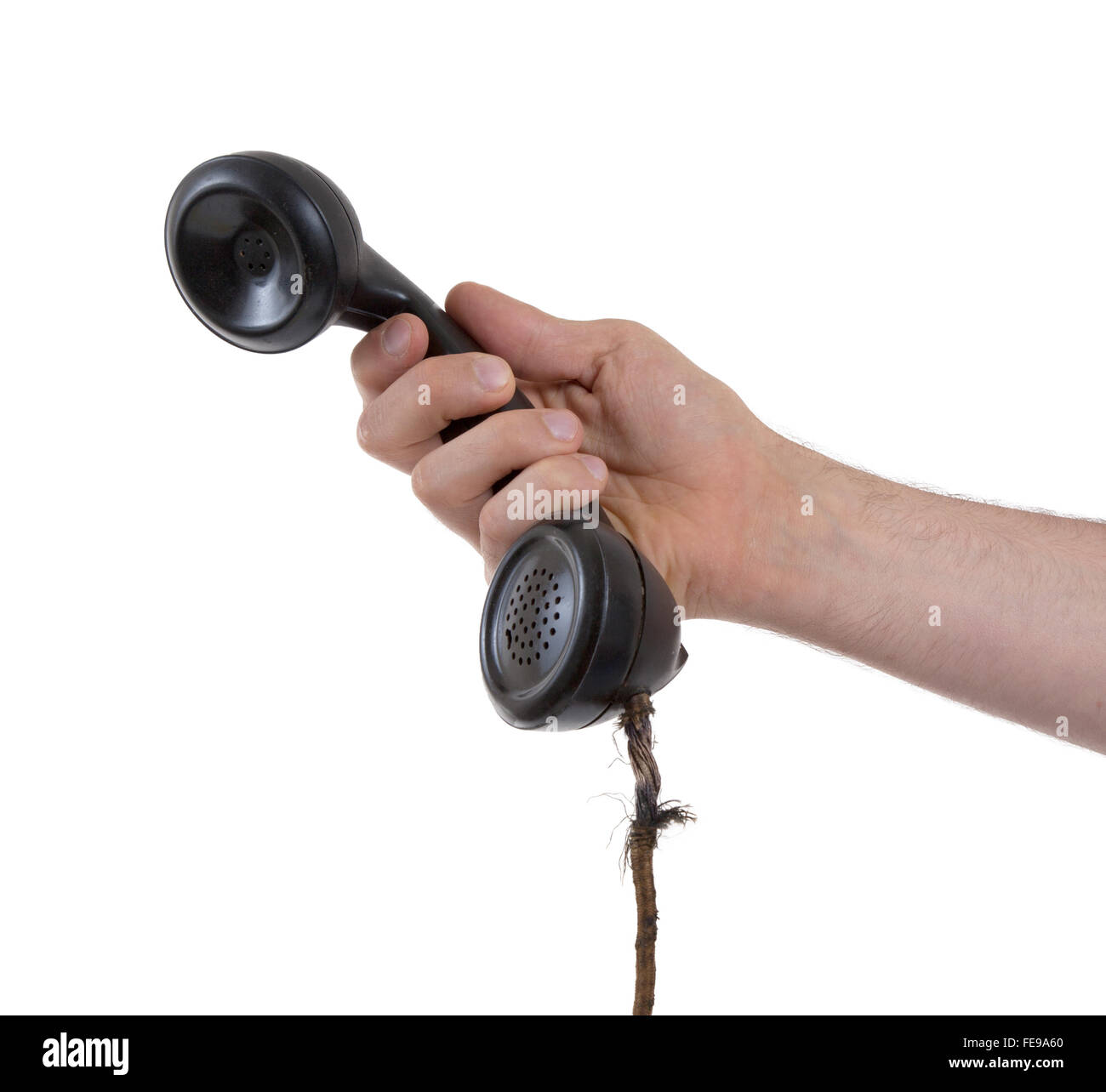 Male hand holding retro landline telephone, nearly broken cable Stock Photo