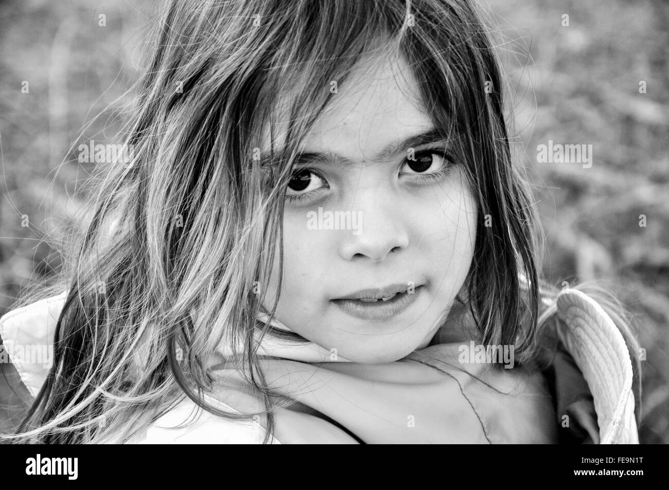 Young blonde girl is posing outdoor looking at the camera. Argentina, near Buenos Aires. Stock Photo