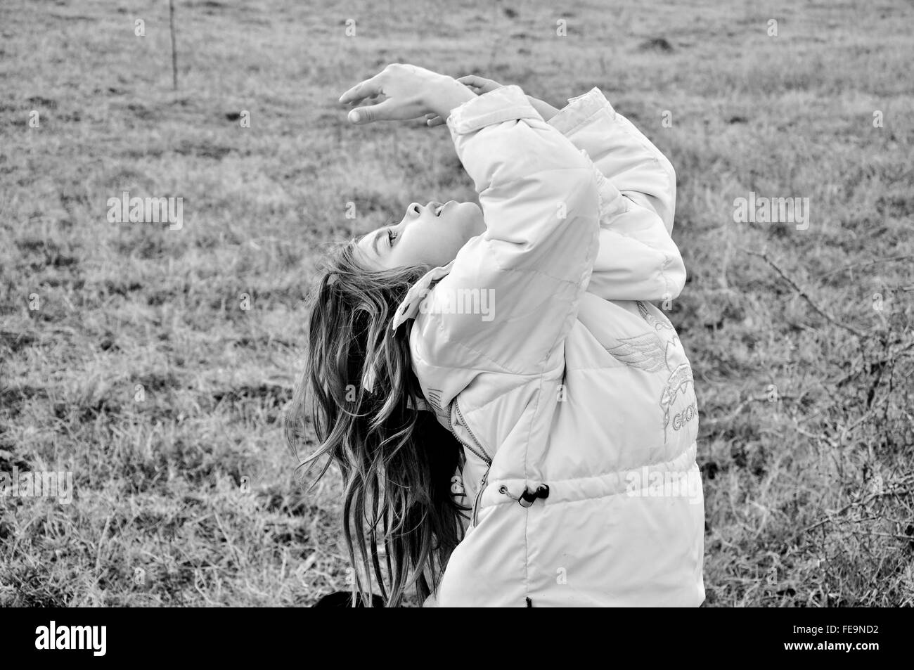 Young girl dancing dancing outdoor in the middle of a cold winter, Stock Photo