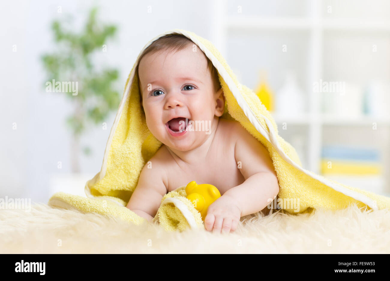 Funny baby kid under towel after bath Stock Photo Alamy