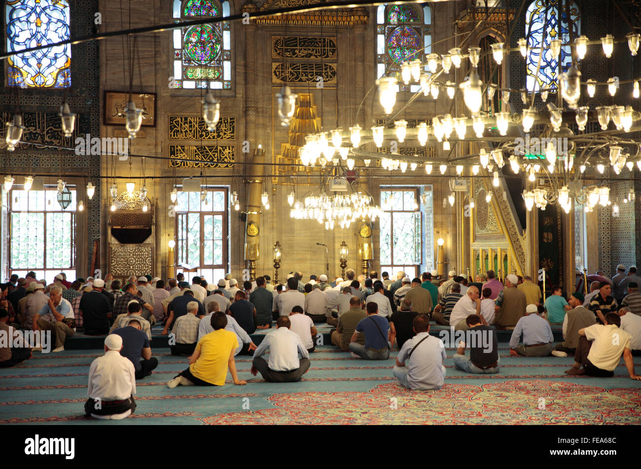 People praying in Yeni Cami Mosque, Istanbul, Turkey Stock Photo