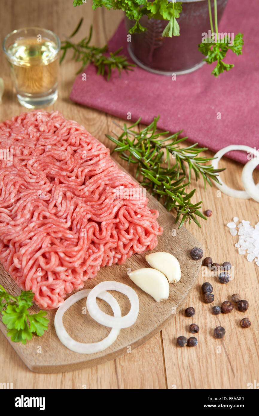 raw minced meat of pork and beef fresh on a wooden board with ingredients Stock Photo