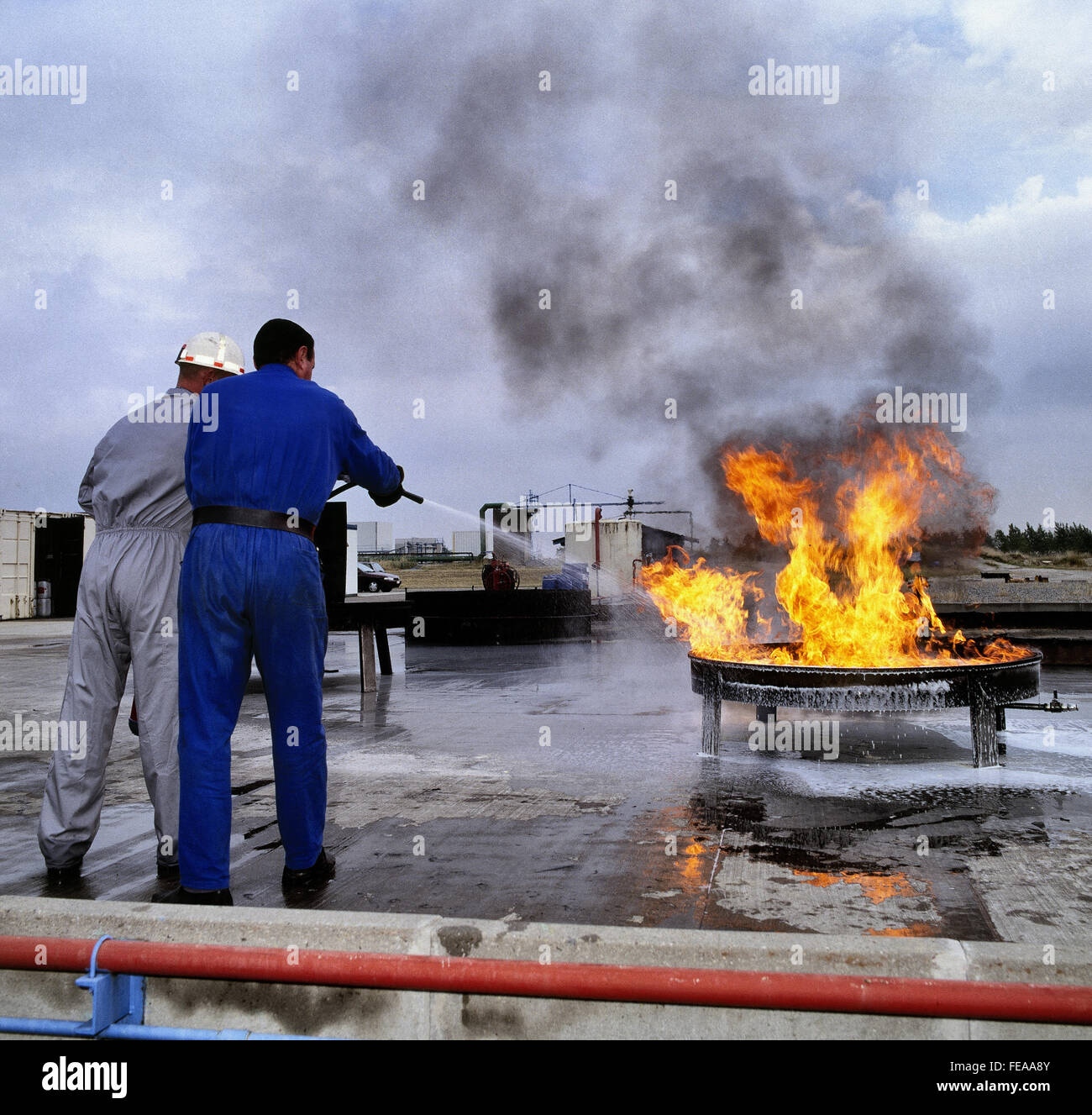Extinguishing with fluide type fire extinguisher, Fire training center. Scanned image from year 1992 Stock Photo