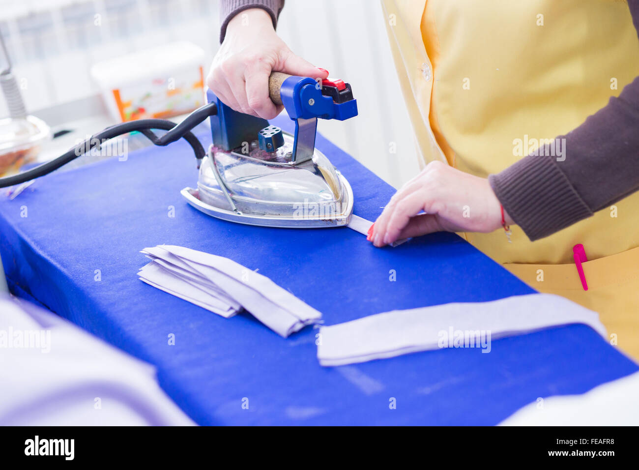 Woman ironing clothes at work Stock Photo Alamy