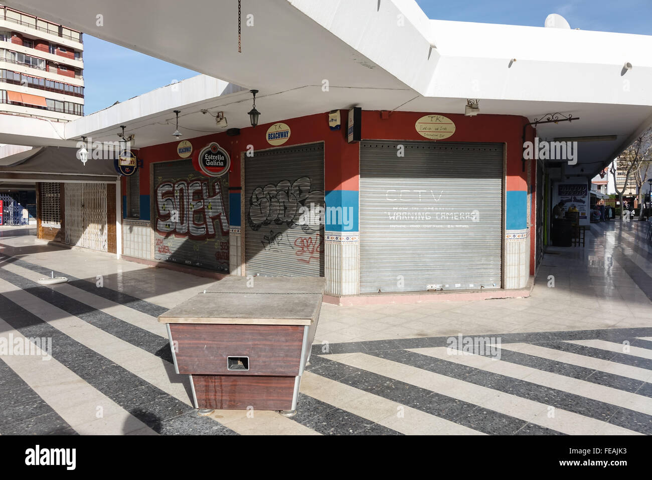 Failed British pub bar in a precinct in Benidorm, Alicante Province, Spain all closed up for sale and unsold Stock Photo