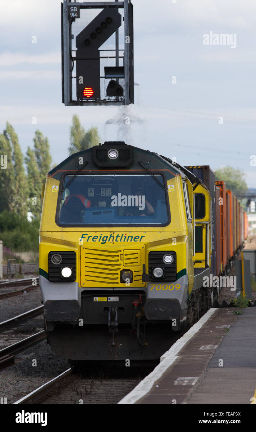 A freightliner container train hauled by a Class 70 Diesel locomotive passes through Didcot Parkway. Stock Photo