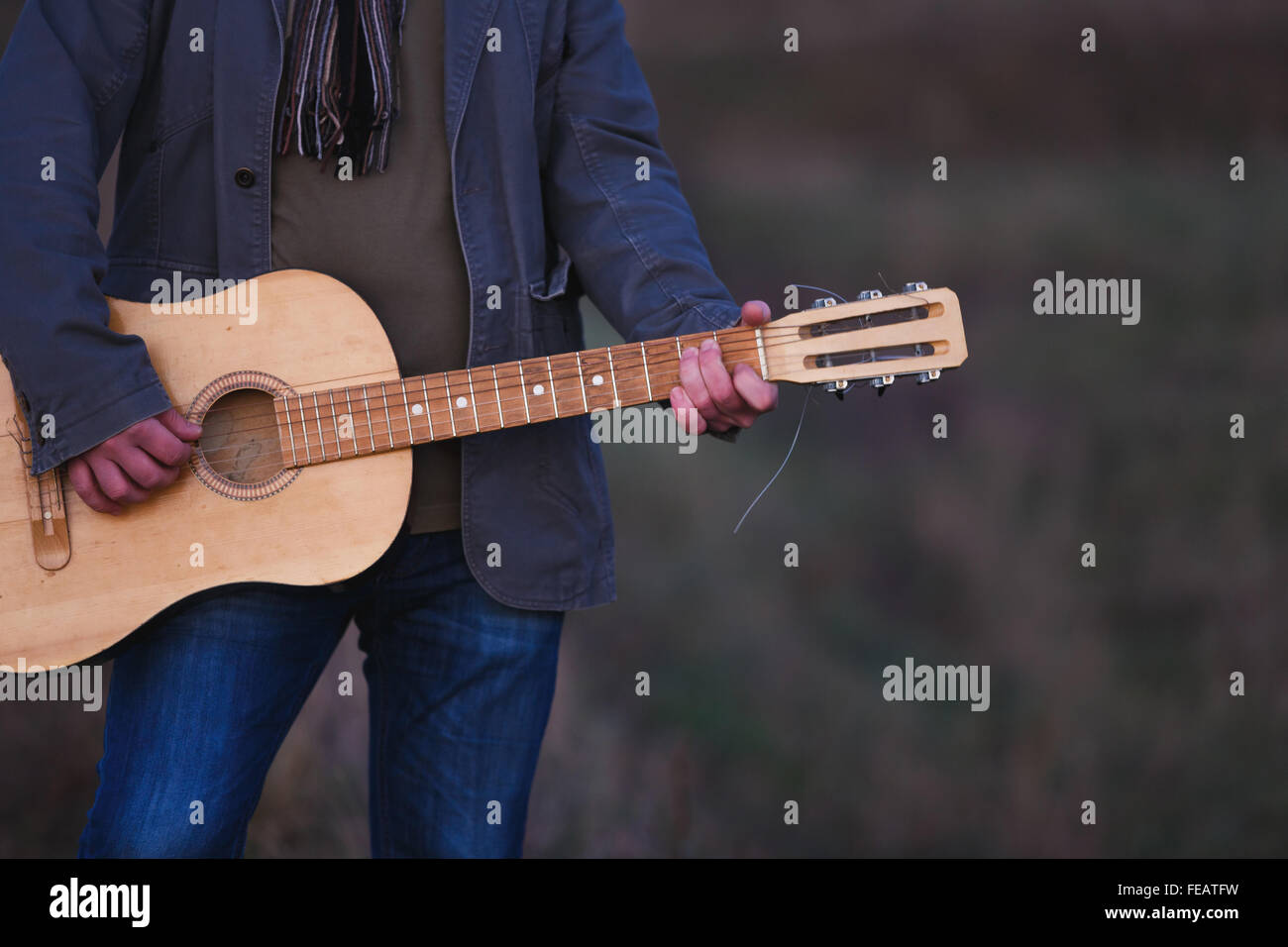 Man with the old acoustic guitar outdoor Stock Photo