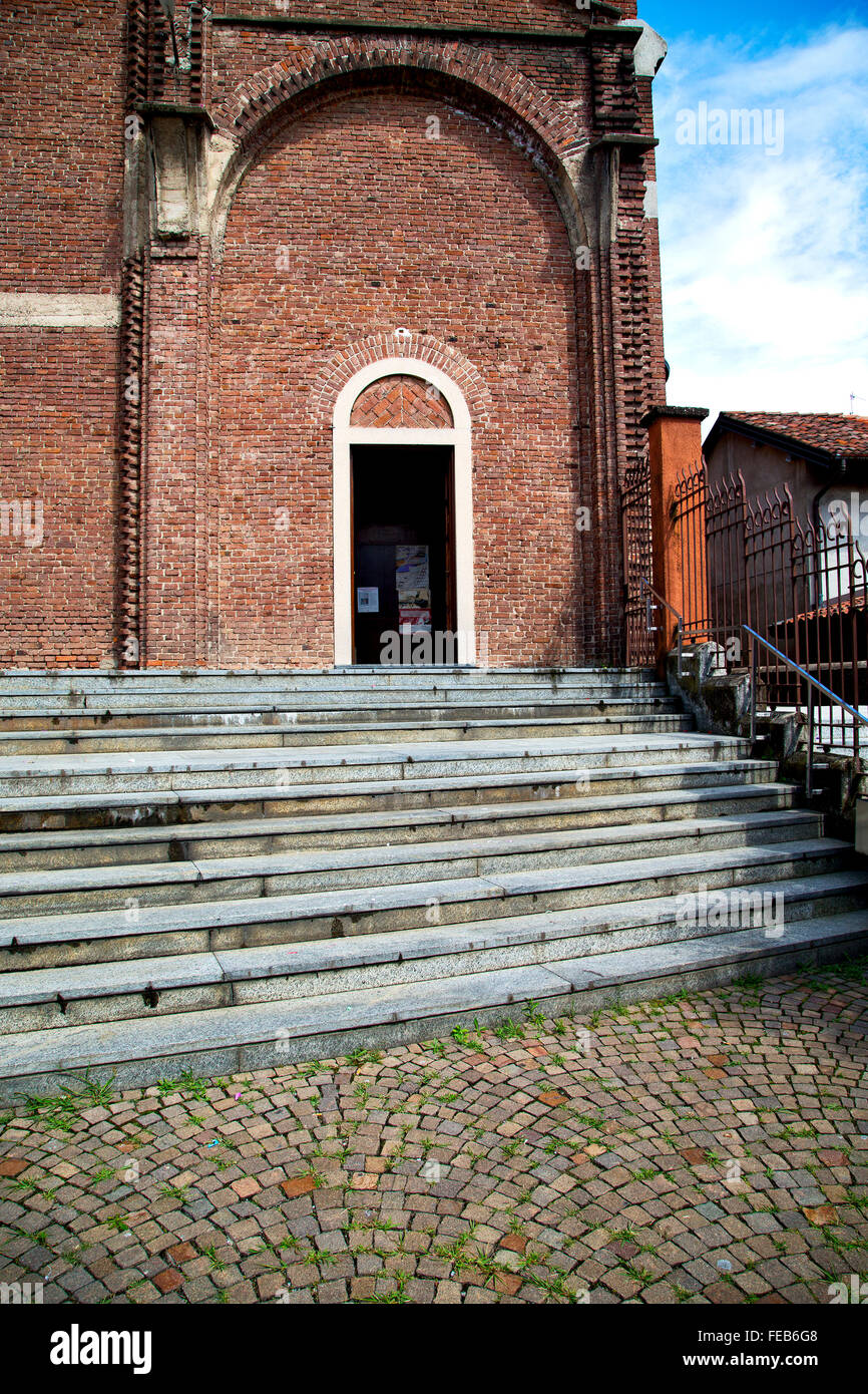 lombardy    in  the  cardano al campo  old   church  closed brick tower sidewalk italy Stock Photo